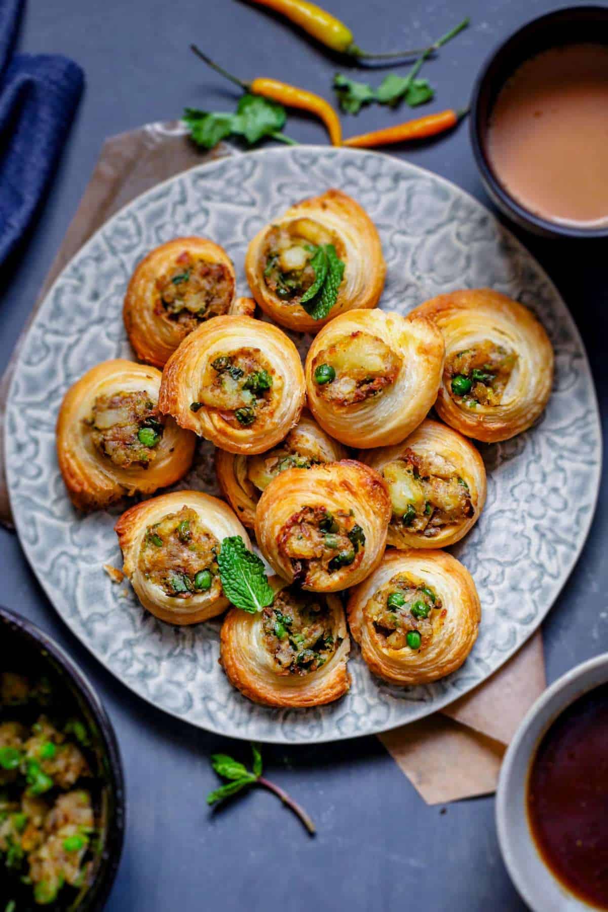 Close up shot of aloo samosa pinwheels with samosa filling in center.