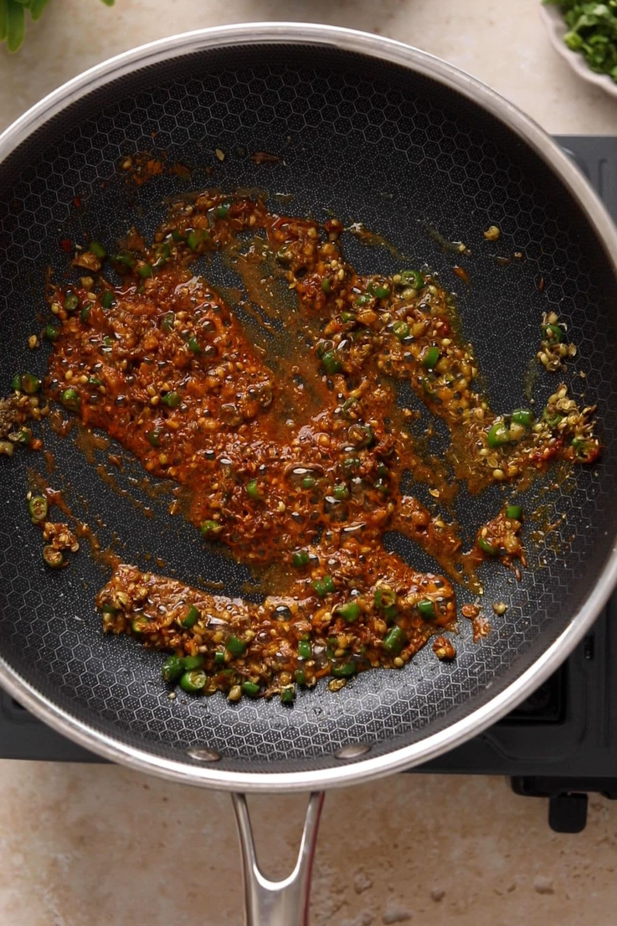 Spices are fried over low heat to make a flavorful base for samosa filling.