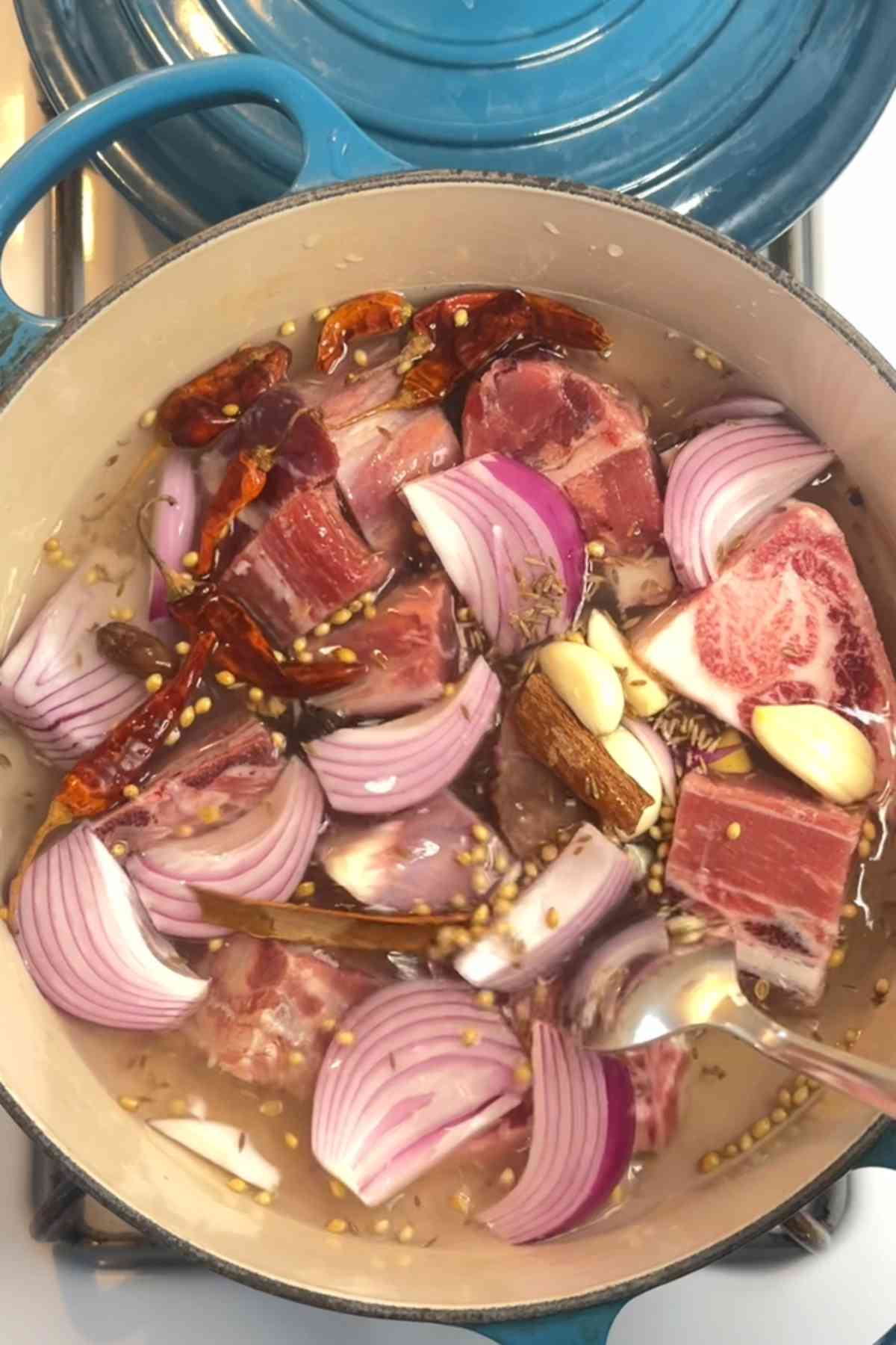 Making yakhnai or mutton stock in a dutch oven.