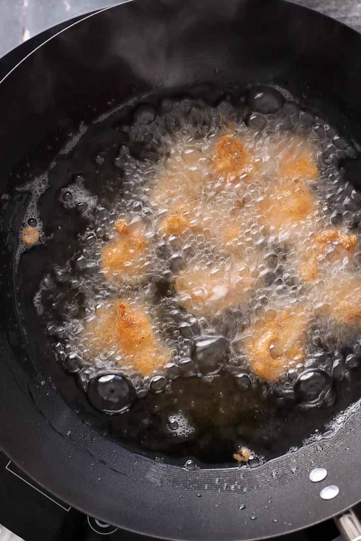 Deep frying chicken to make manchurian.