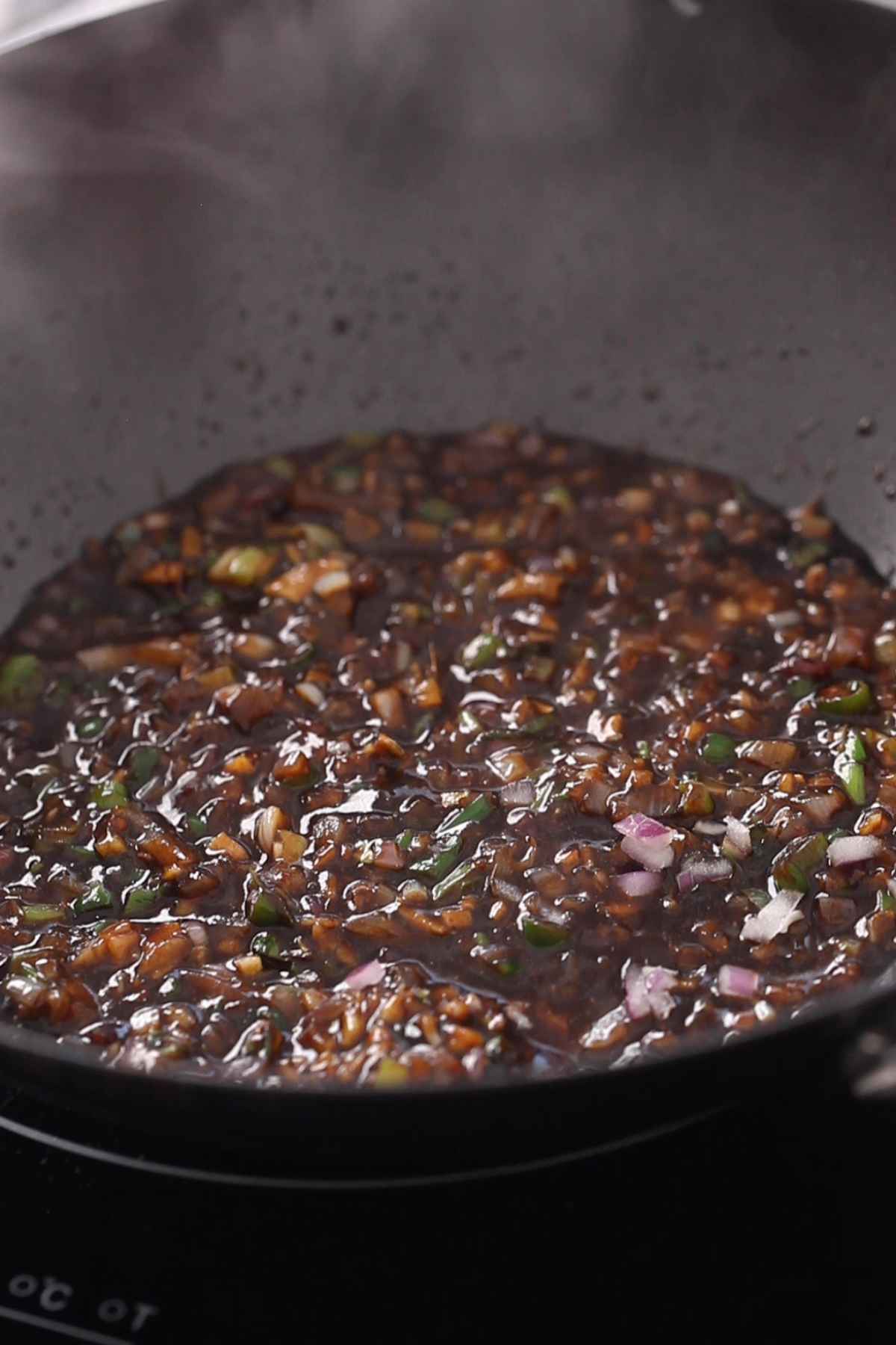 Cooking the machurian sauce till its bubbly.
