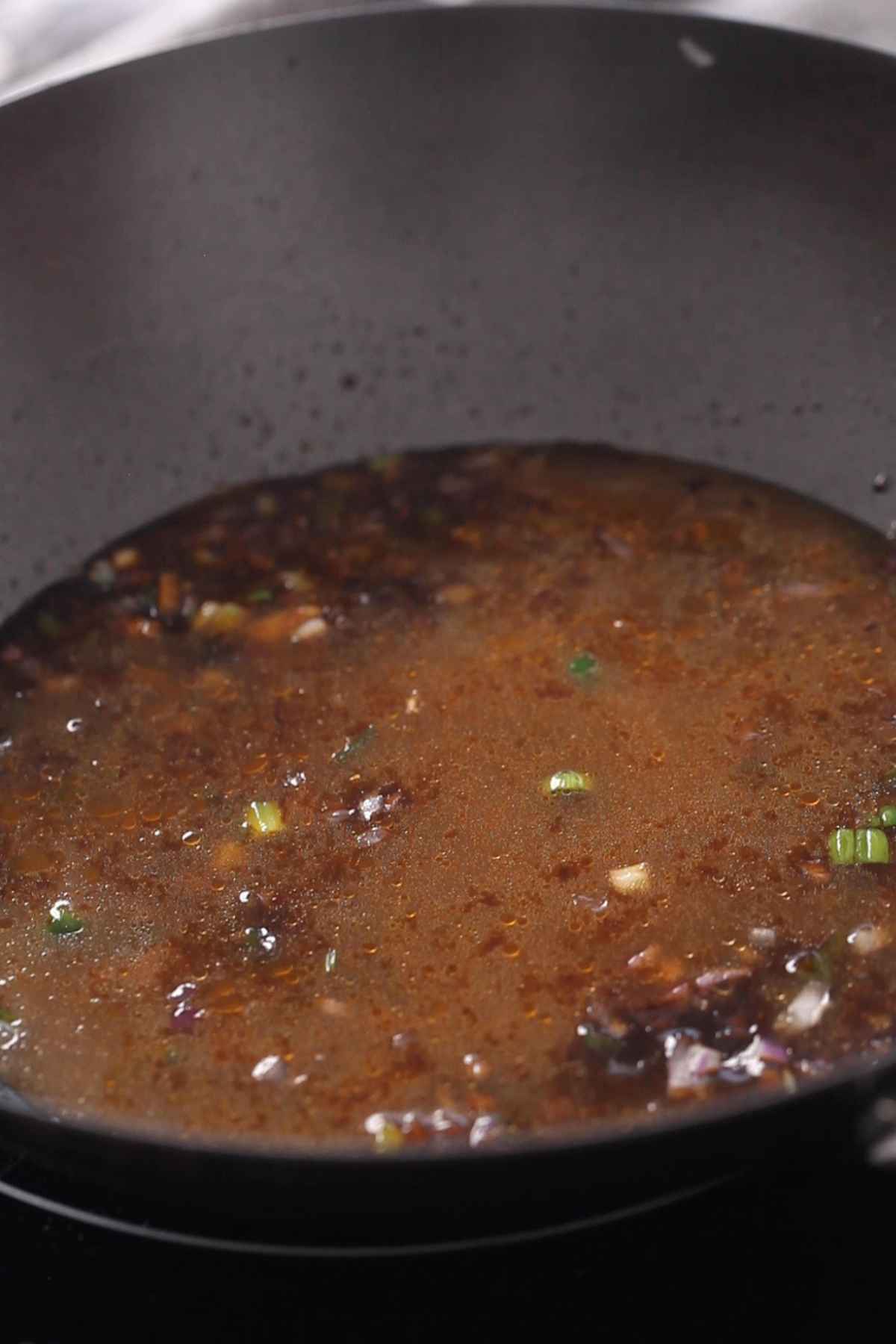 Adding chicken stock and letting slow boil. 