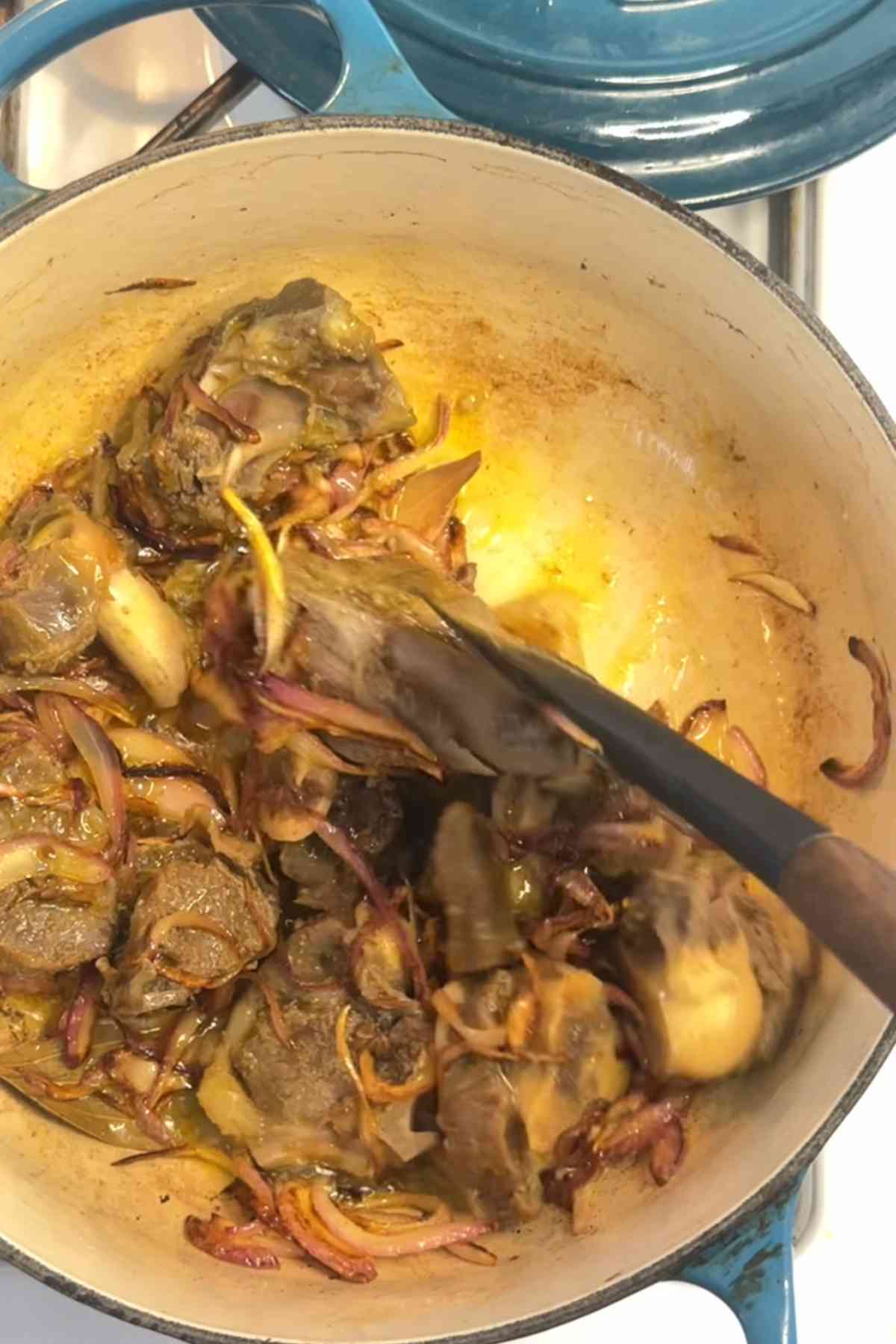 Frying mutton pieces with onions.