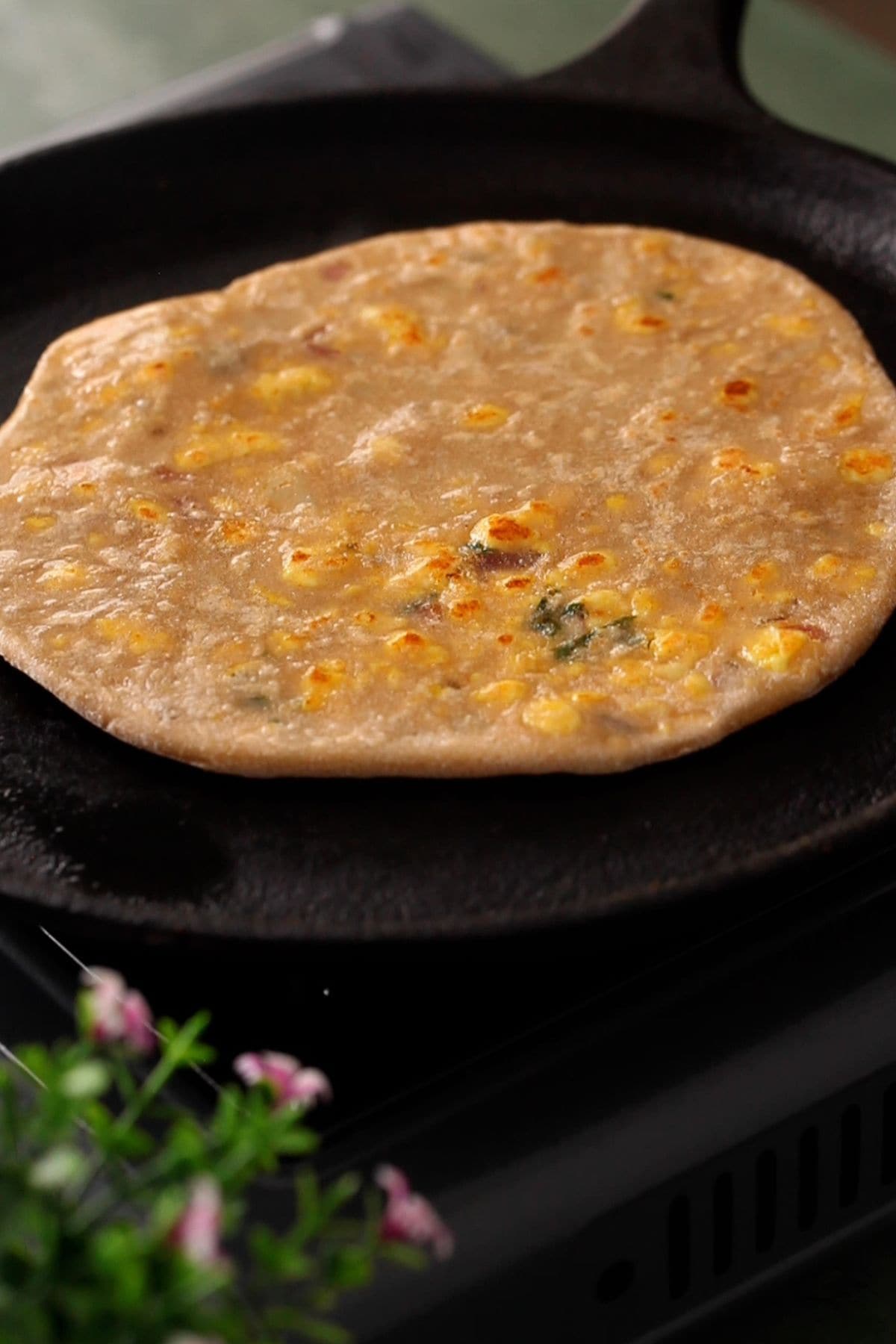 Ghee is brushed whle cooking the paratha.