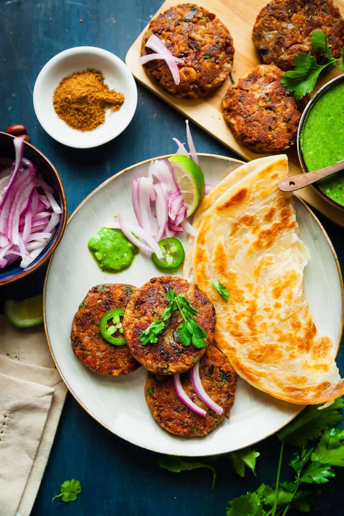 Kidney bean kebab patties with flatbread and onions and chutney.