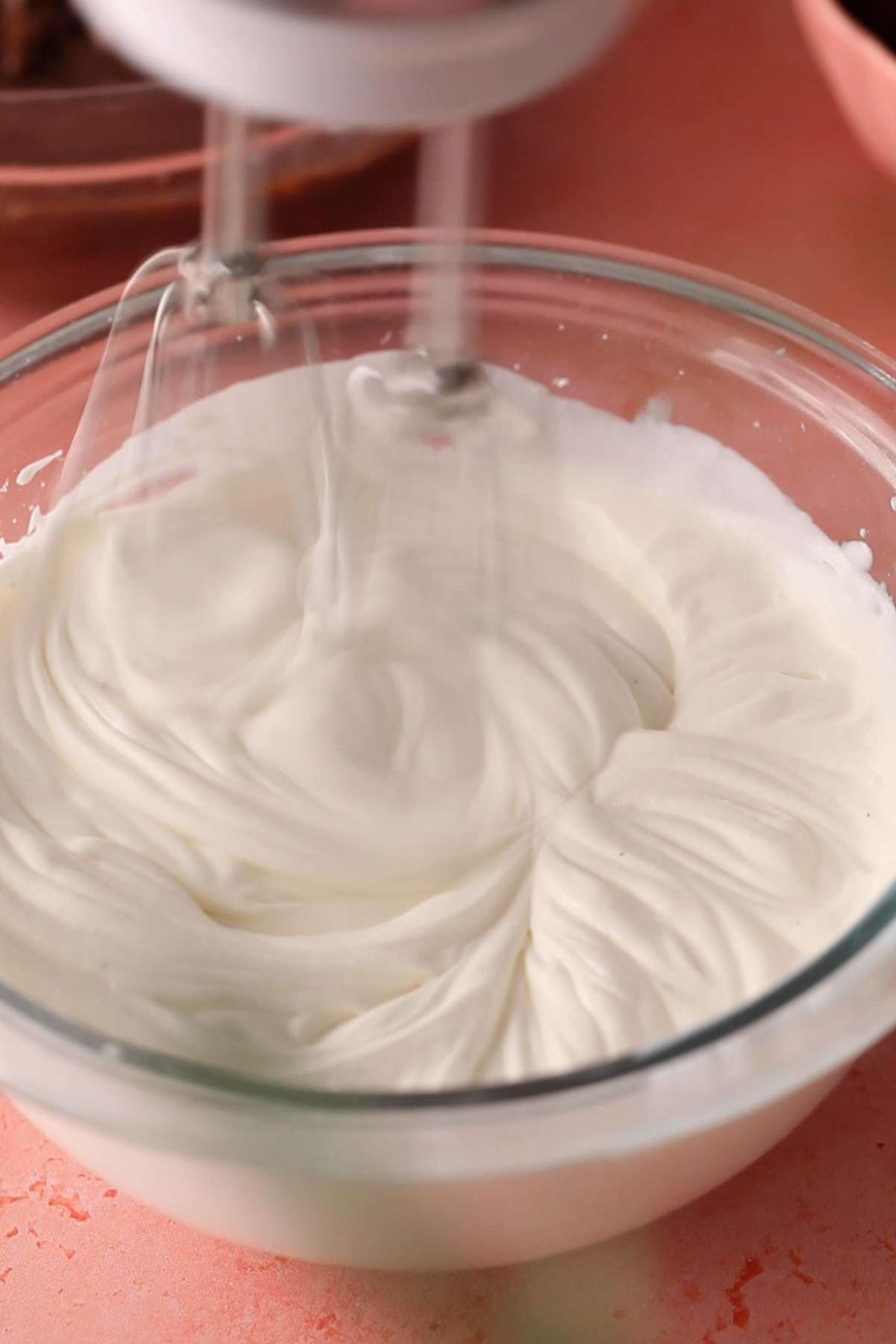 Beating heavy cream with hand mixer.