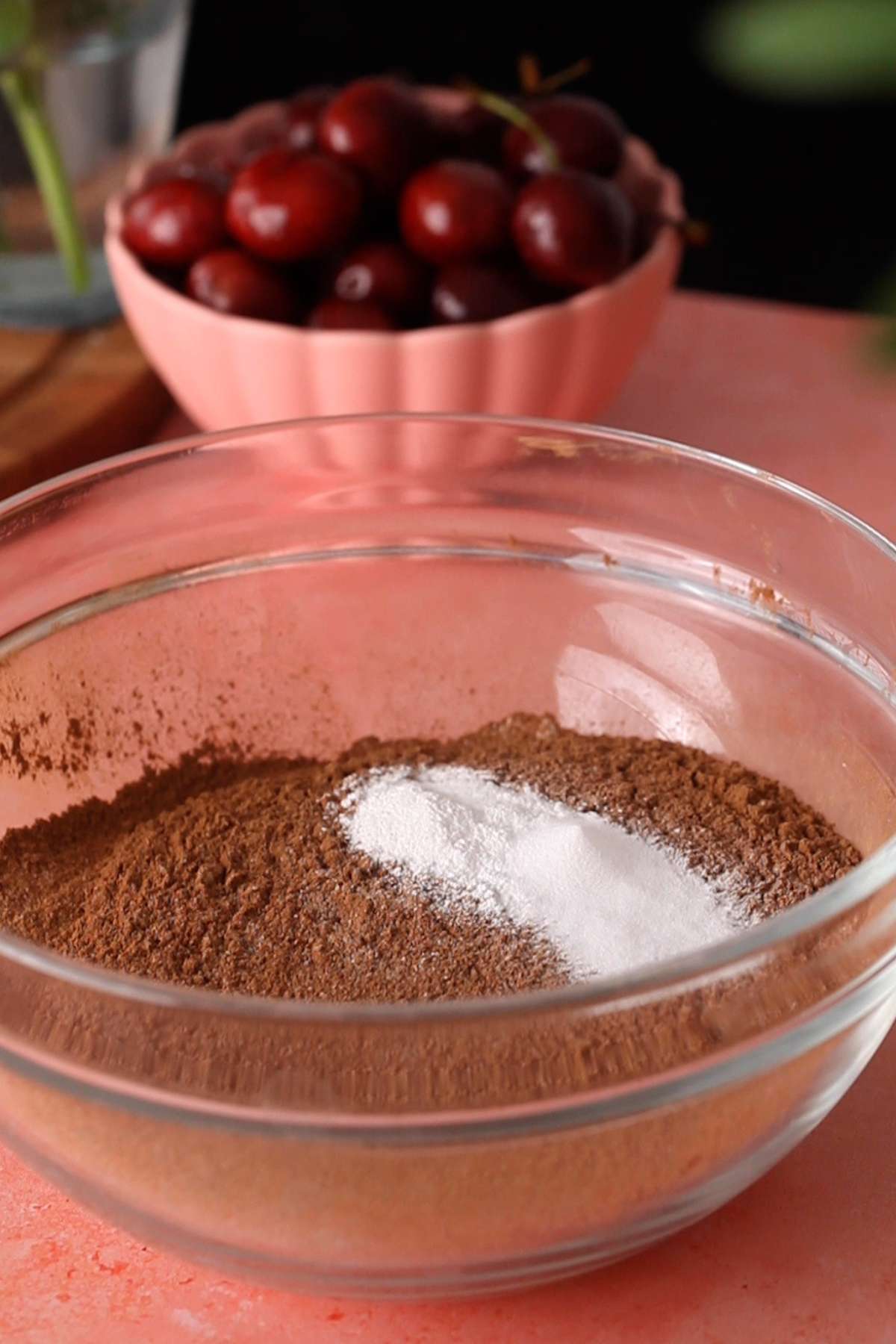 Dry ingredients for the chocolate cake in a glass bowl.