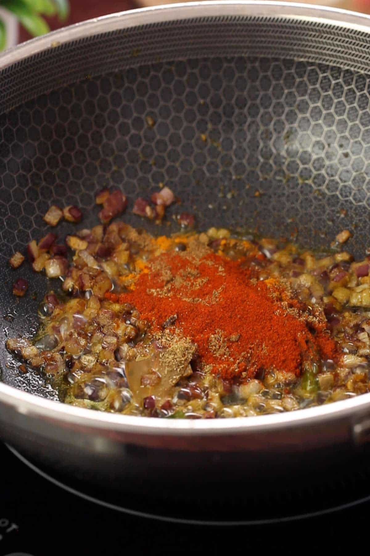 Ground spices added to browned onions.