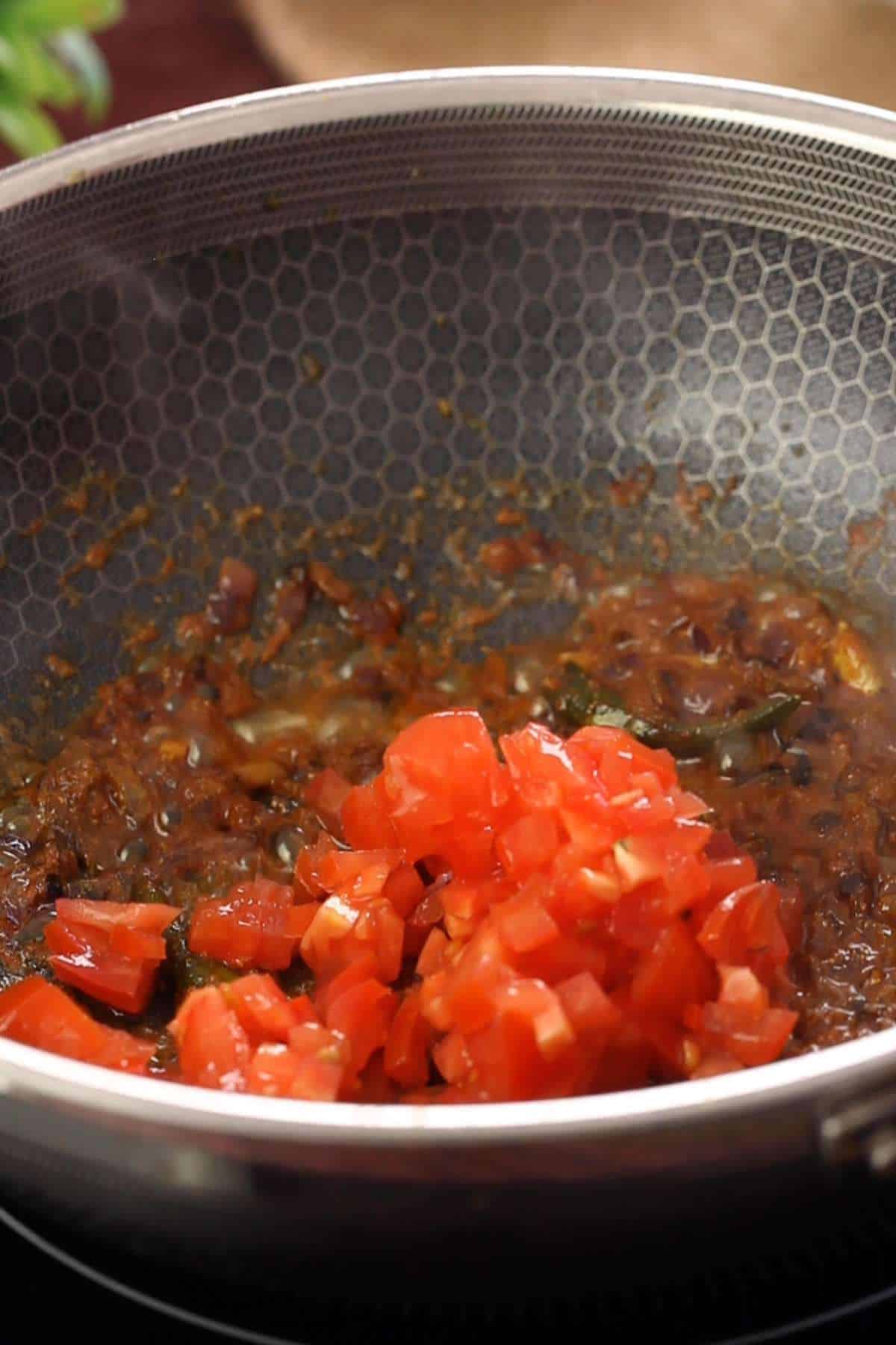 Tomatoes added to make the masala.