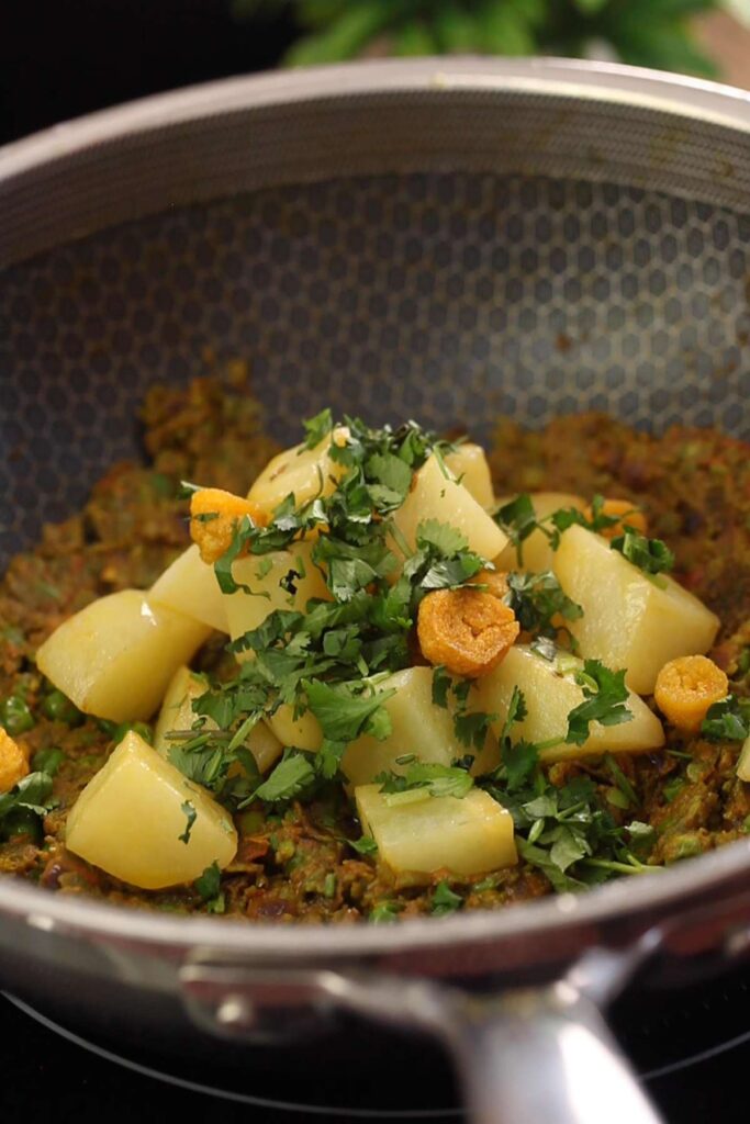 Add back the potatoes, wadi and cilantro to peas.
