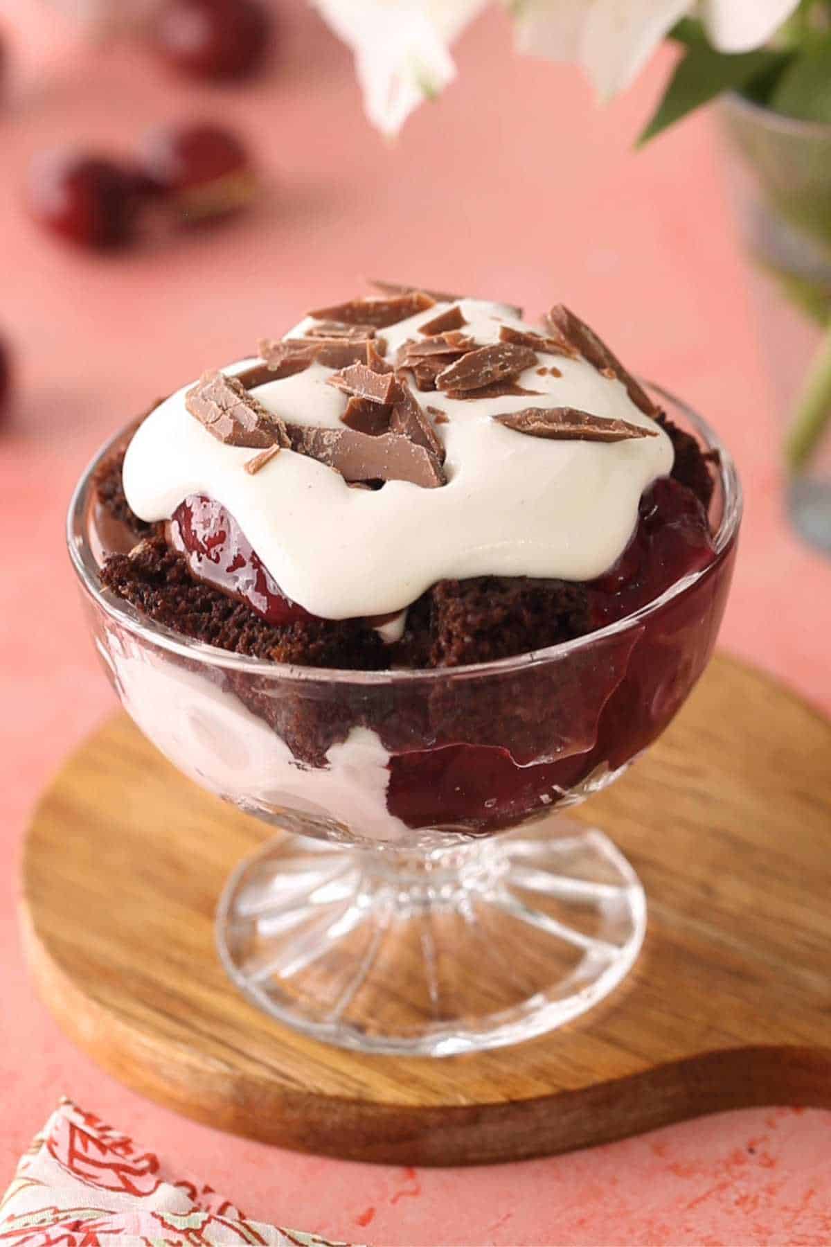 Black forest trifle topped with whipped cream and chocolate shavings.
