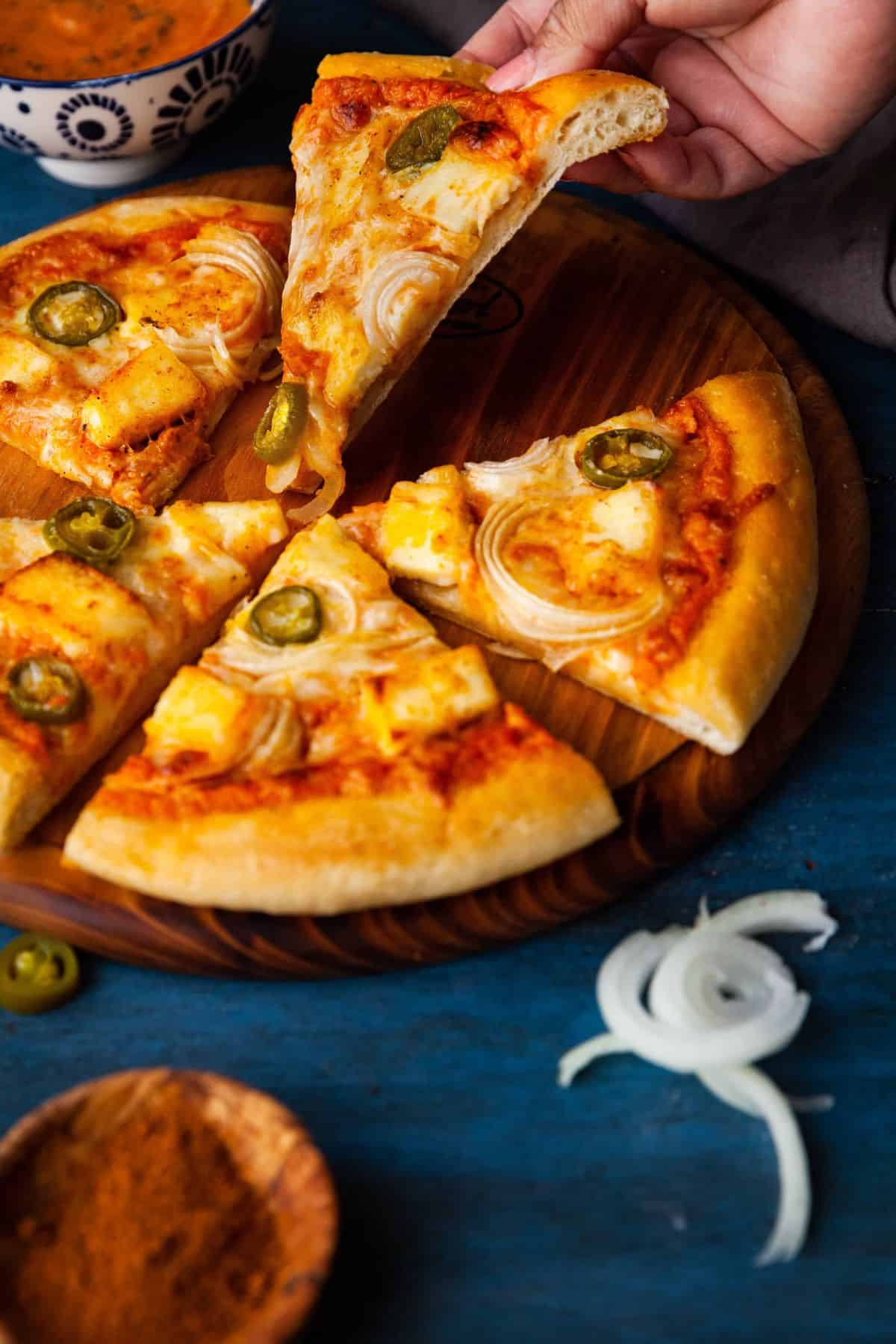 Lifting a pizza slice.