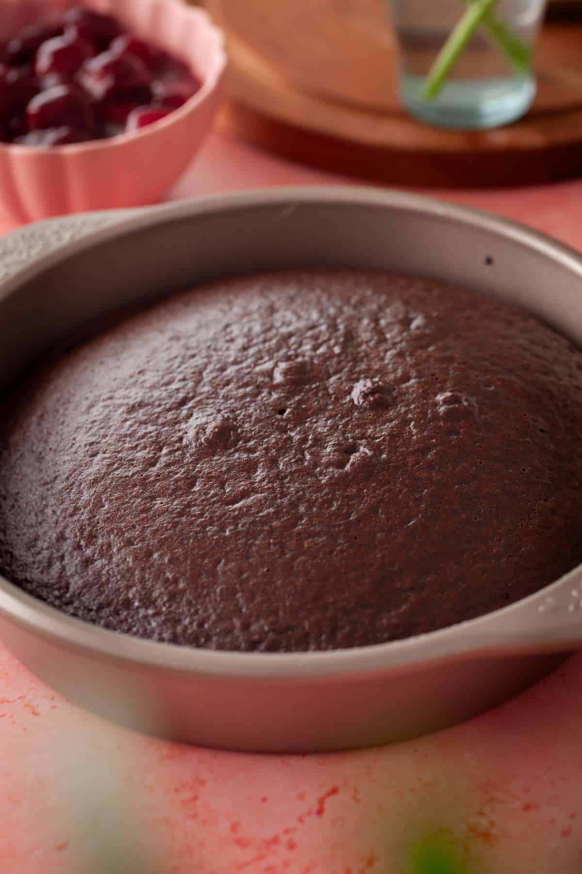 Baked chocolate sponge cake in a cooling in a cake pan.
