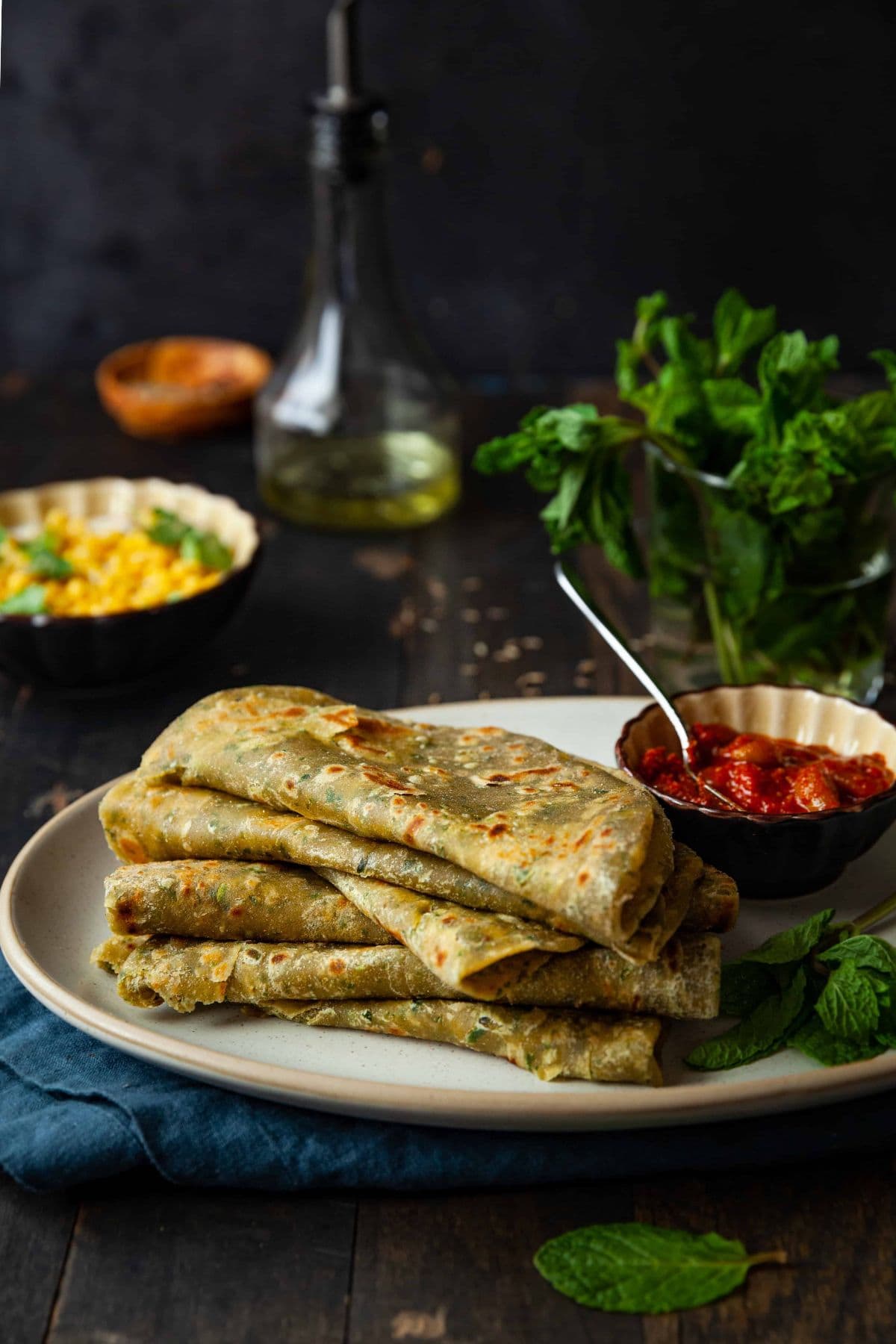 Side view of mint paratha  folded and stacked on top of each other.