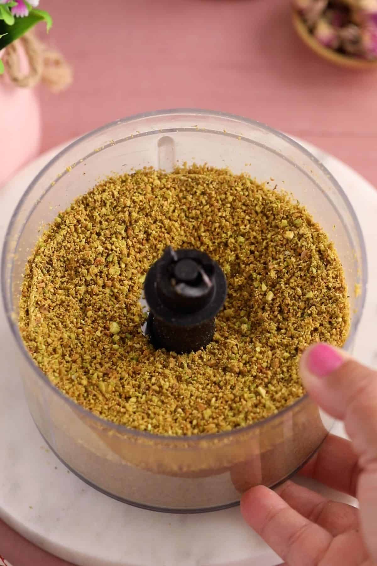 Powdered pistachios in a food processor.