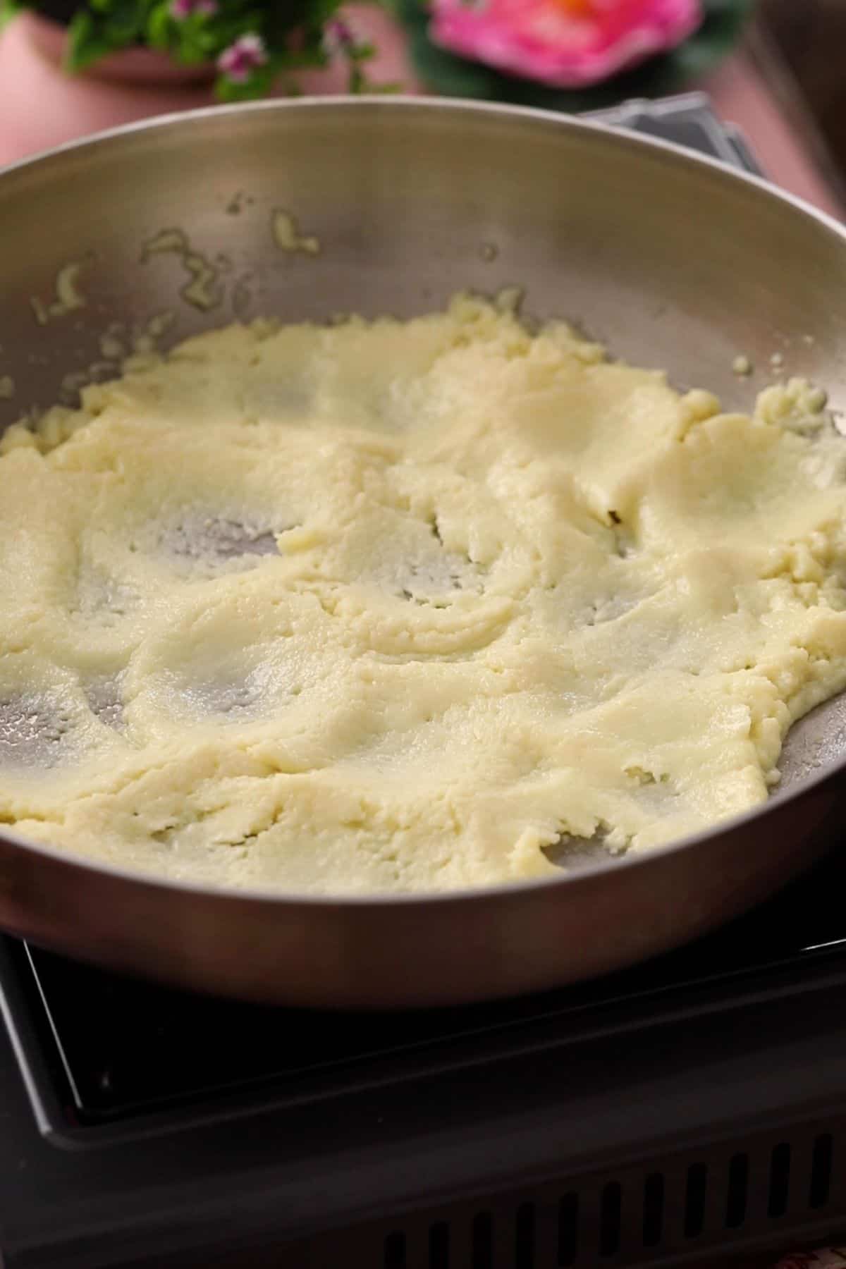 Softened mawa in a steel pan.