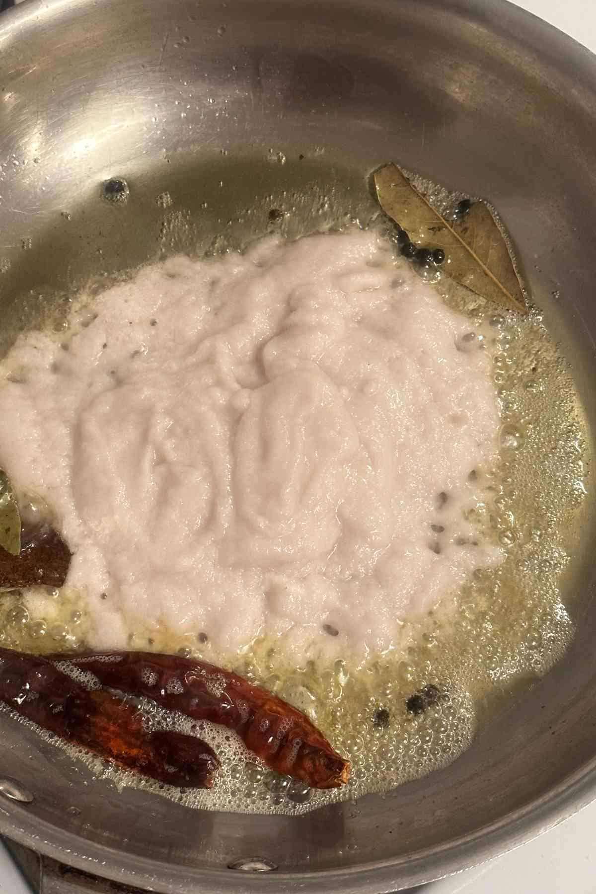 Adding onion pase to ghee.