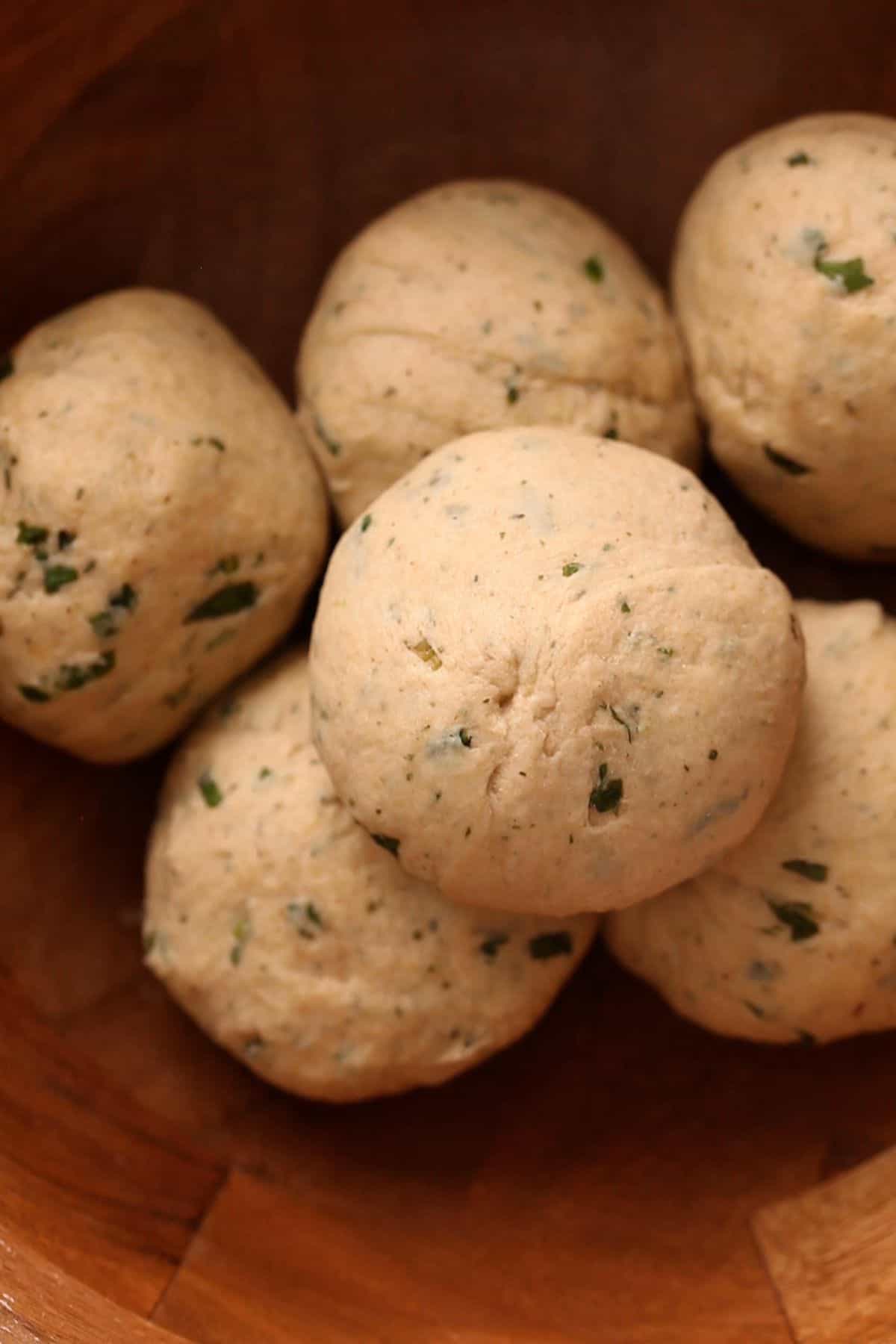 Dough balls for making mint paratha are placed in the wooden bowl. 