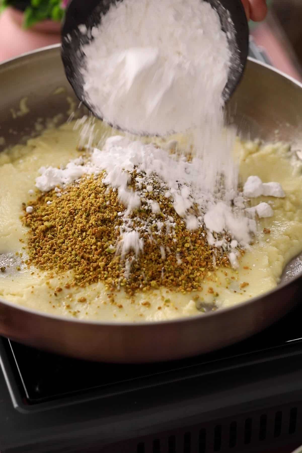 Ground pistachios and sugar is added to soft mawa.