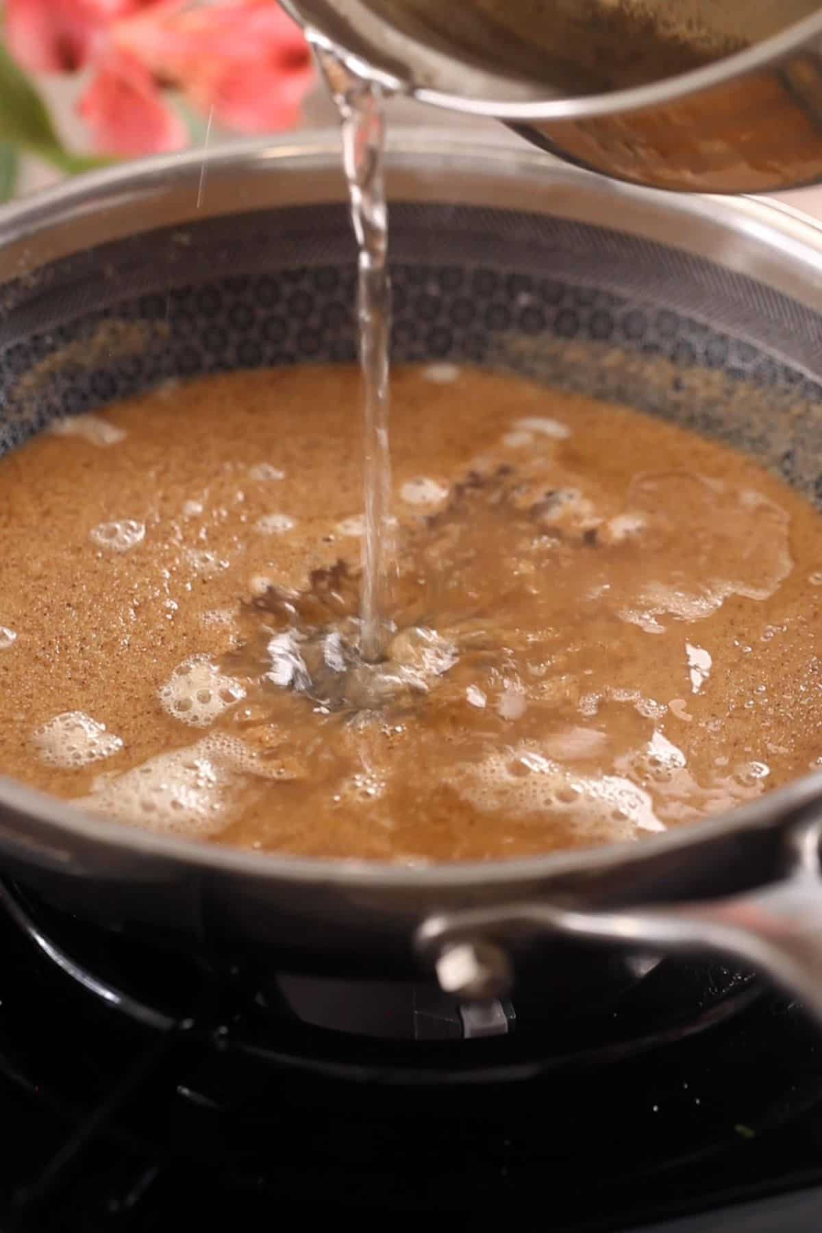 Warm sugar syrup is added to the roasted sooji.