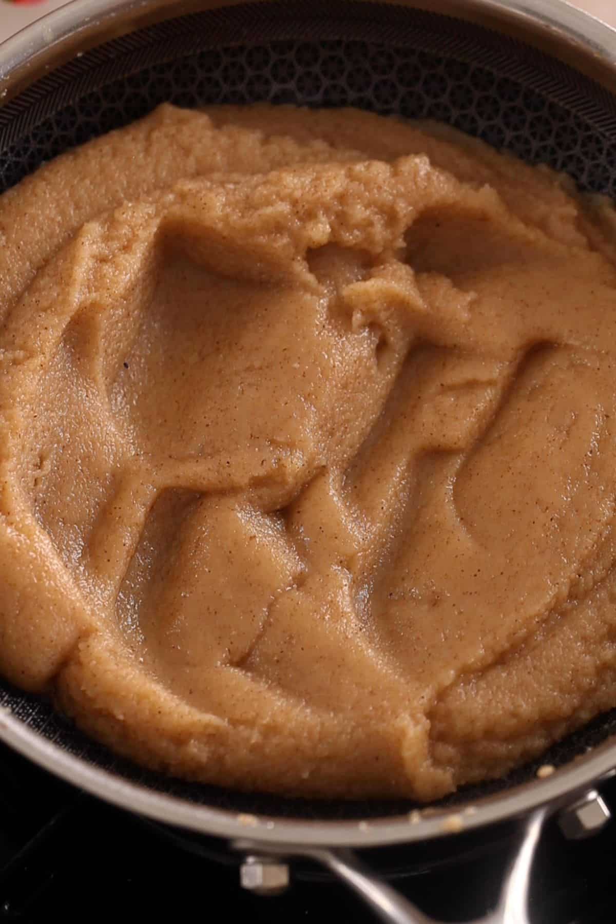 Suji halwa is ready when its shiny and can be folded over itself.