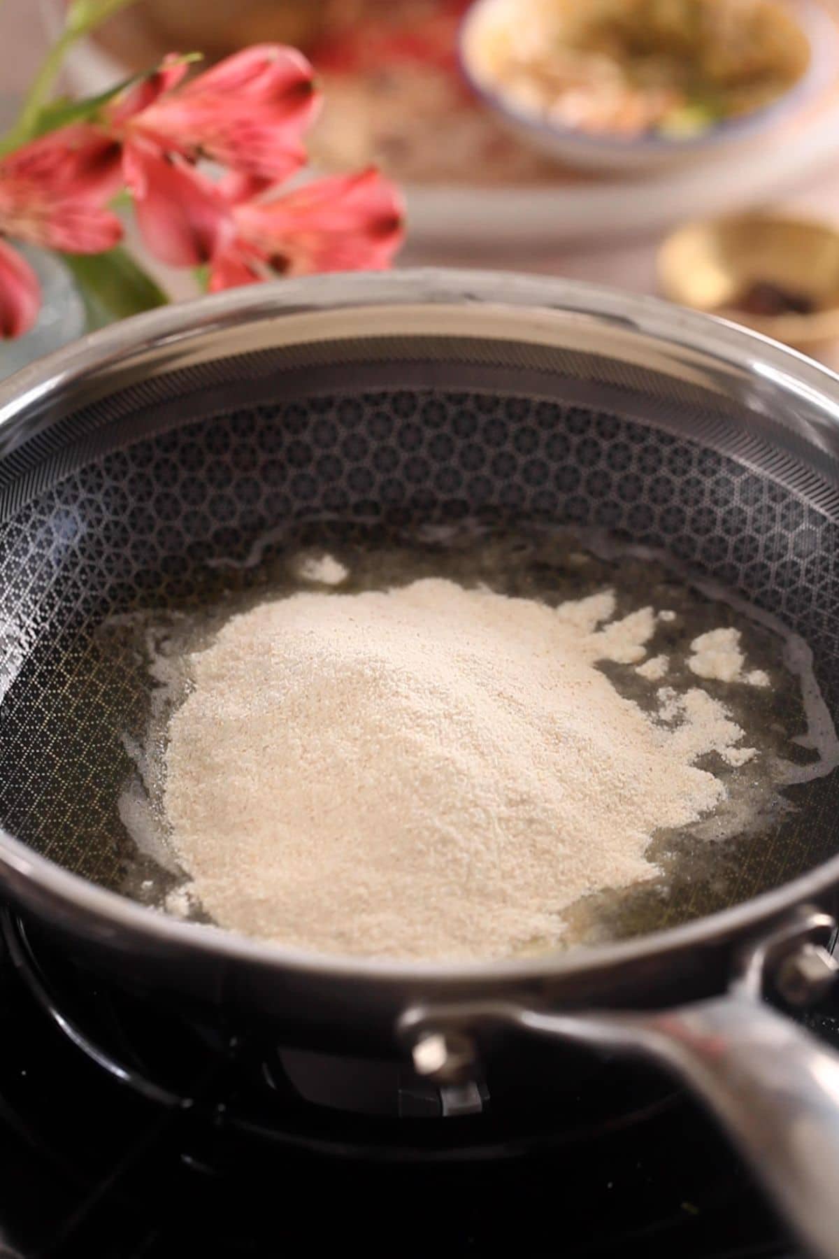 Fine semolina is added to melted ghee.