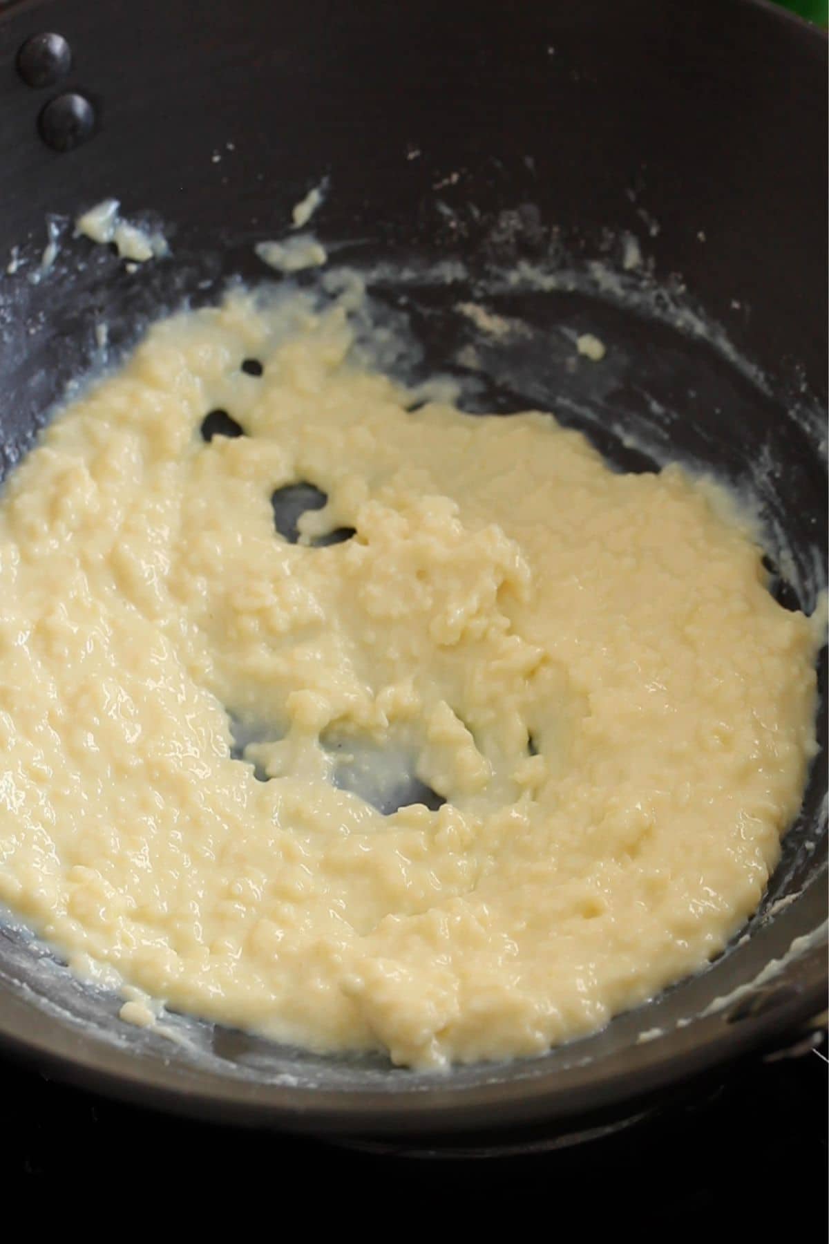 The milk powder mixture is coooked on low heat.