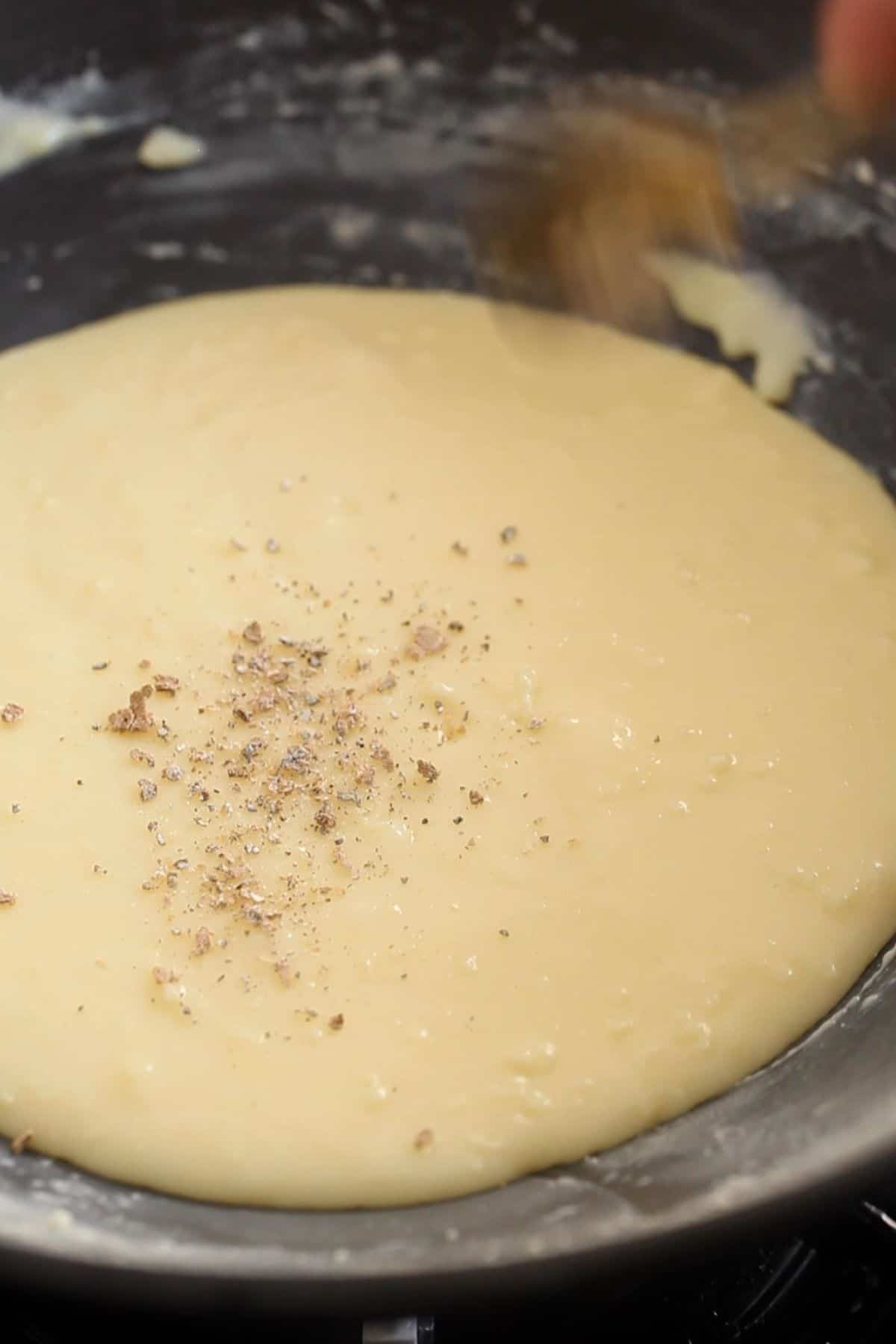 Green cardamom powder is added to flavor the malai peda.