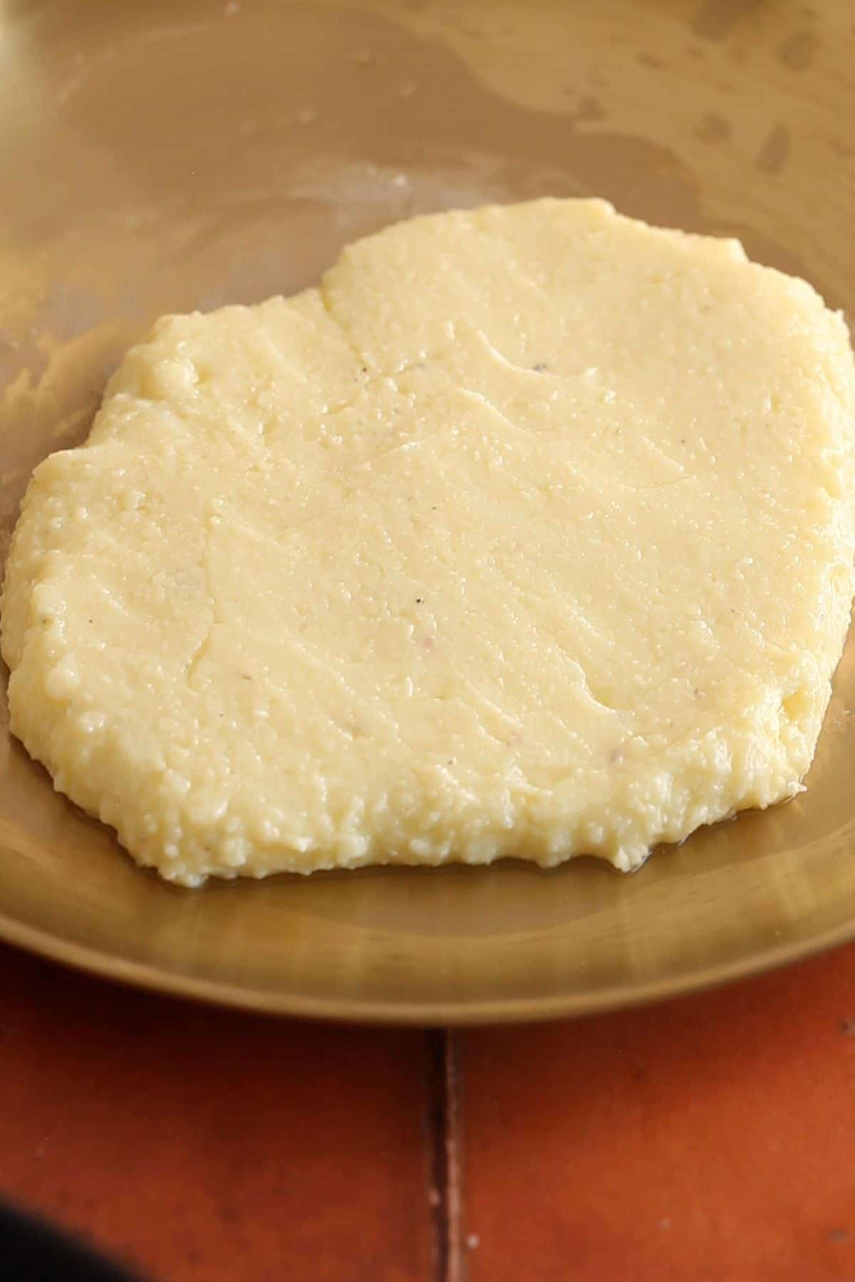 Peda mixture is transfered on a plate to cool down. 