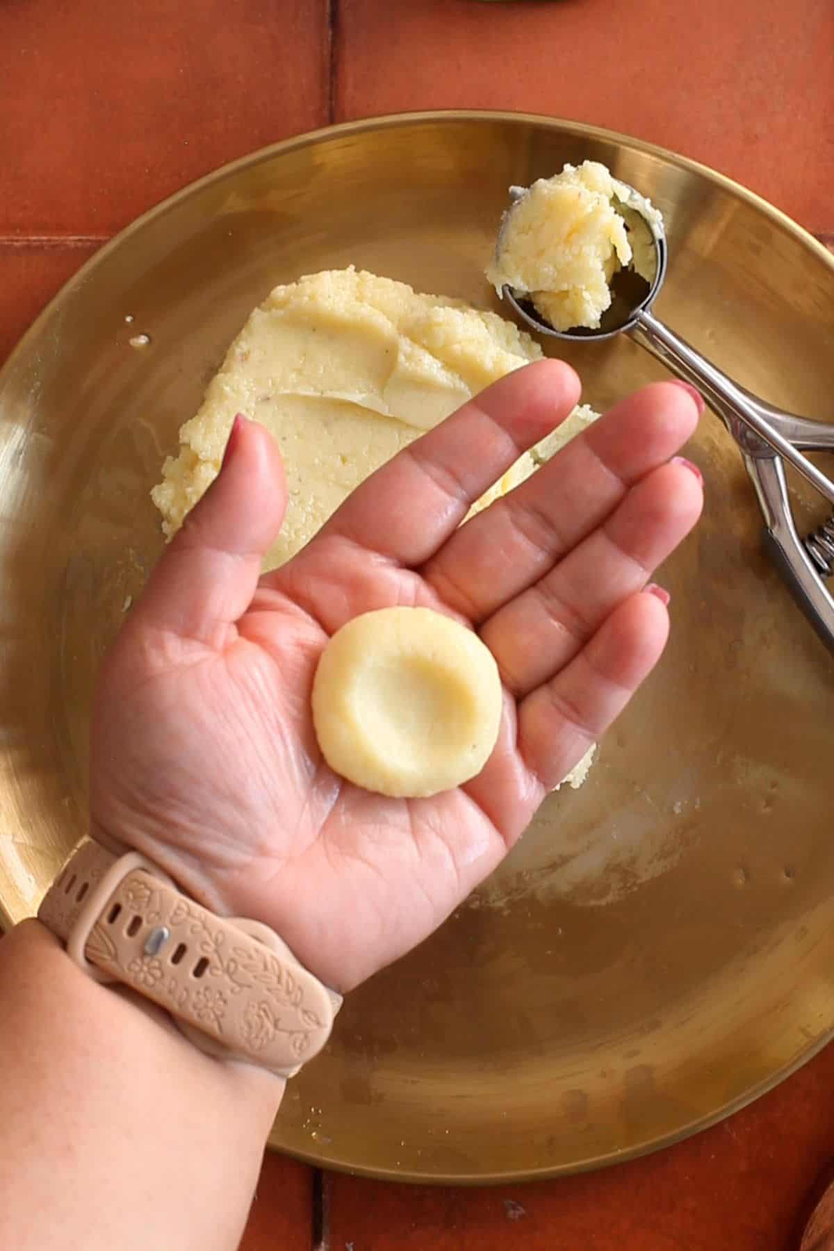 Peda are shaped and pressed in the center.