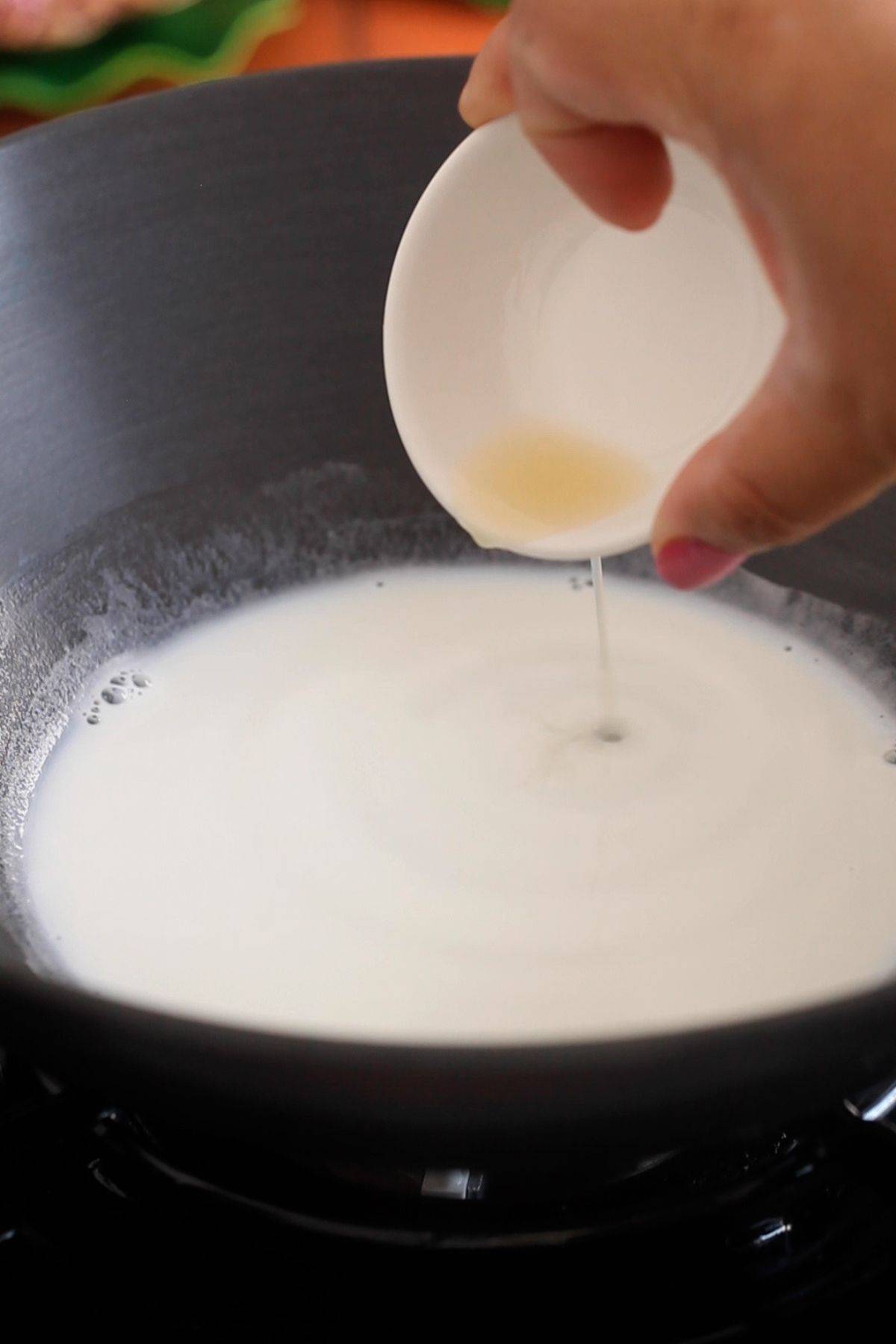 Adding lemon juice to milk. 