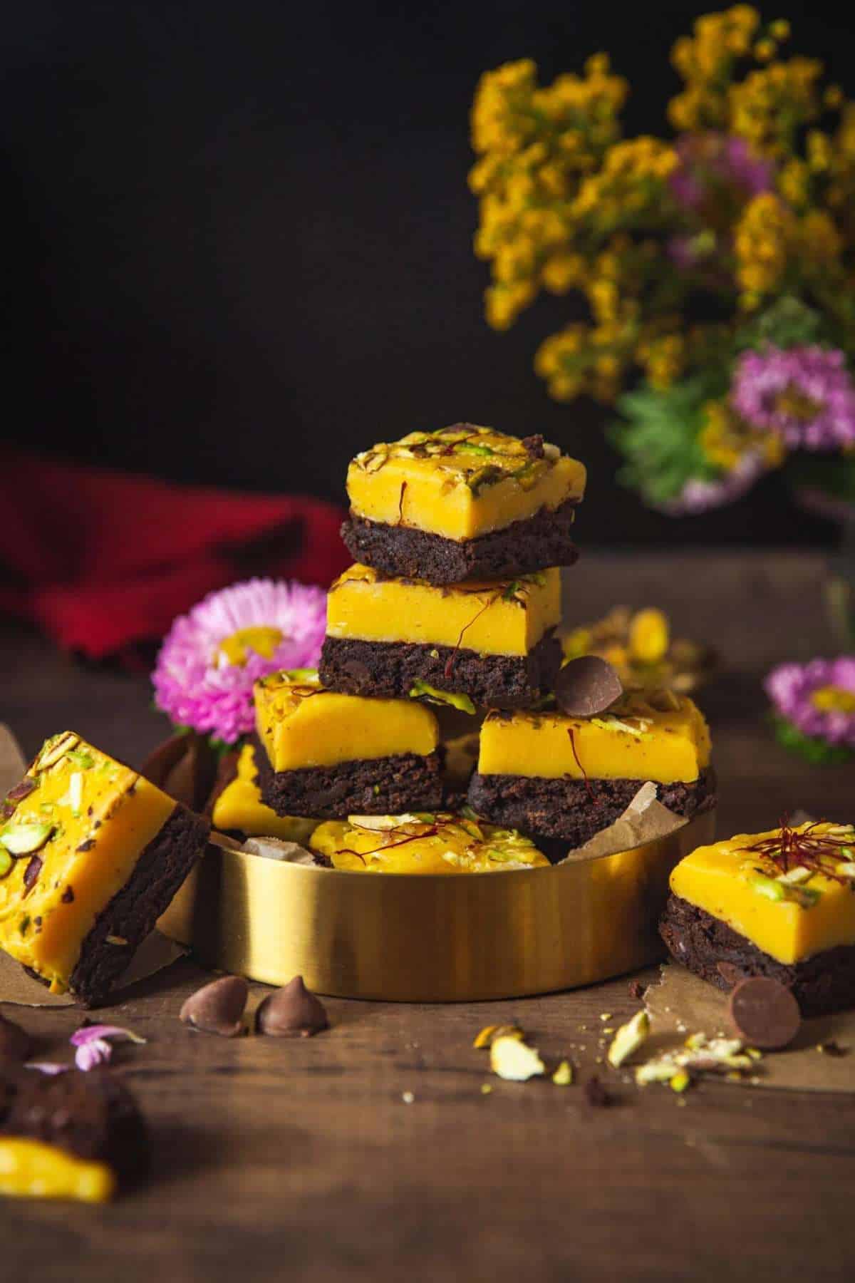 Brownie Burfi Bites stacked on a gold tray. 