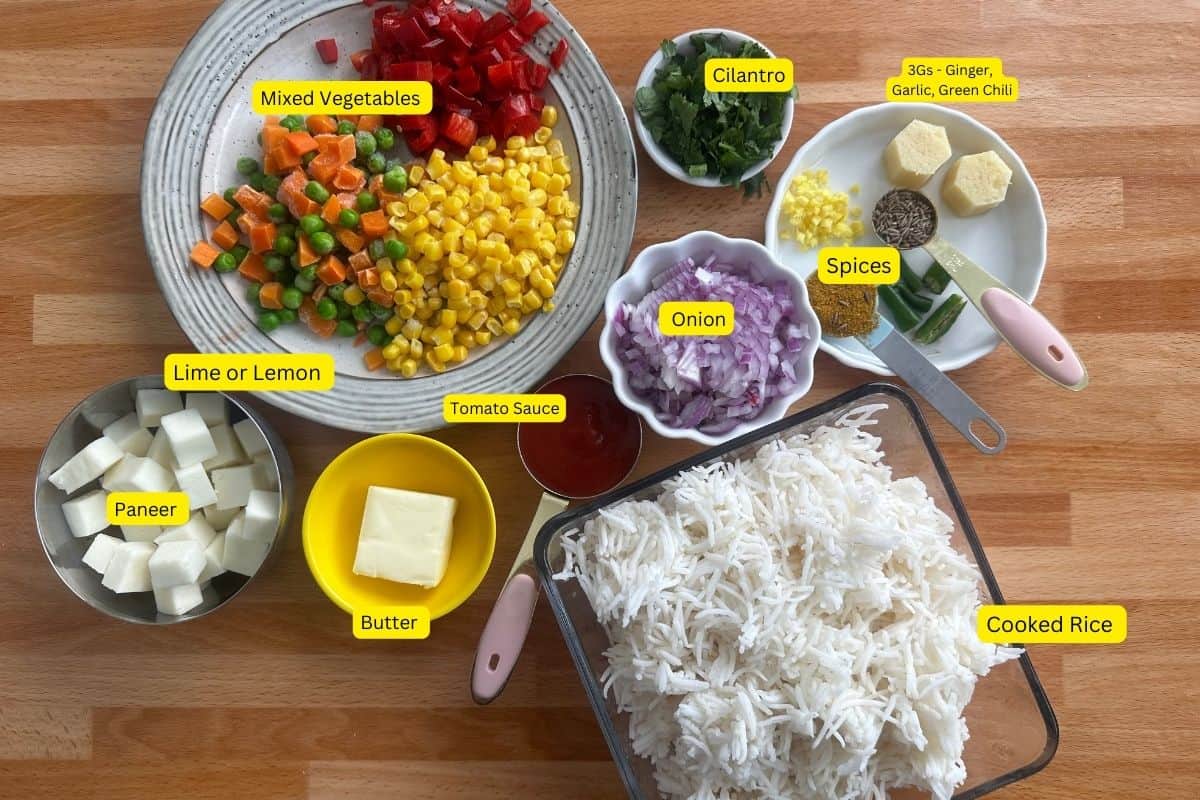 Ingredients needed to make tawa pulao placed on a butchers block background.