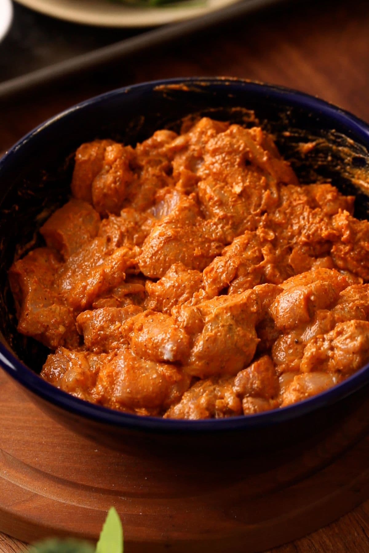 Marinated chicken for chicken 65 in a black bowl. 