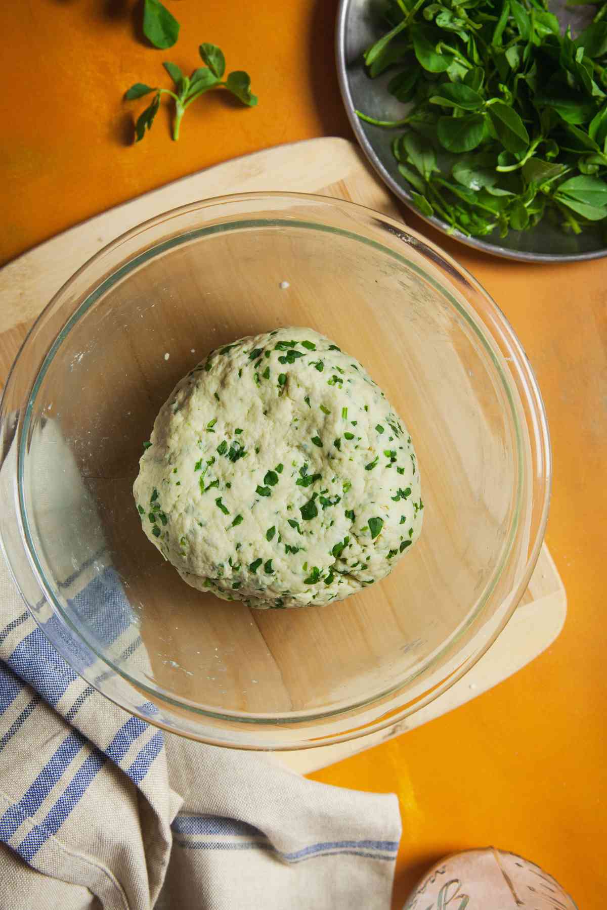 Yeast free naan dough in a glass mixing bowl.