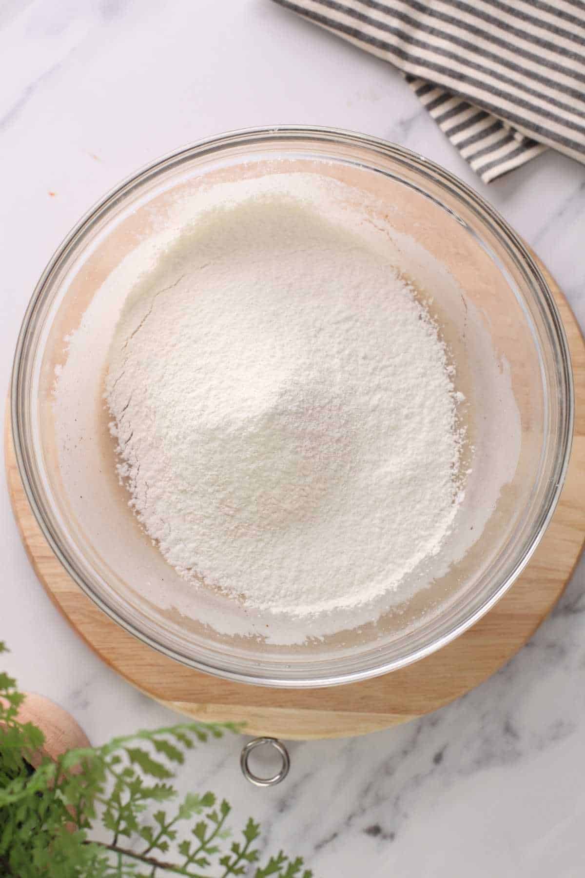 Adding dry ingredients to wet ingredients. 