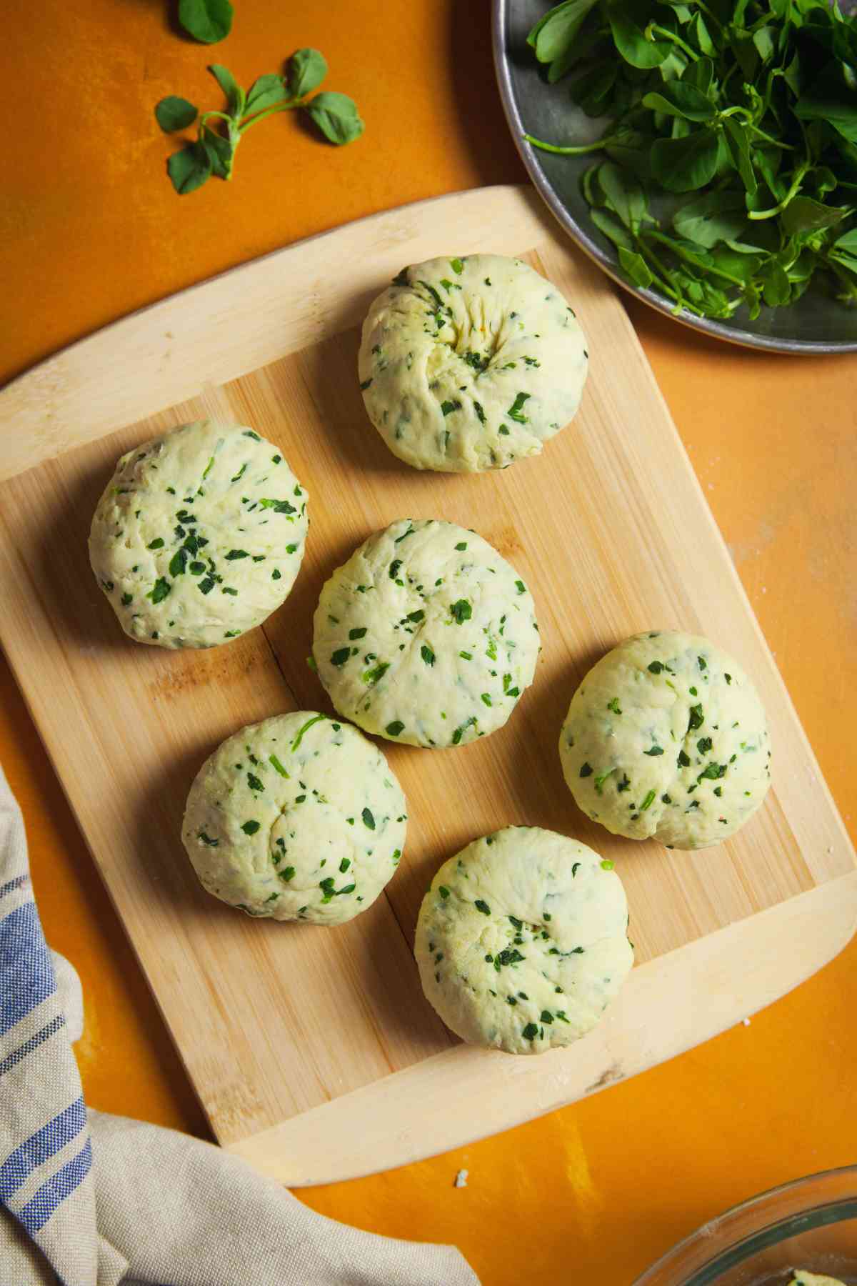 Dough balls placed on the rolling board.