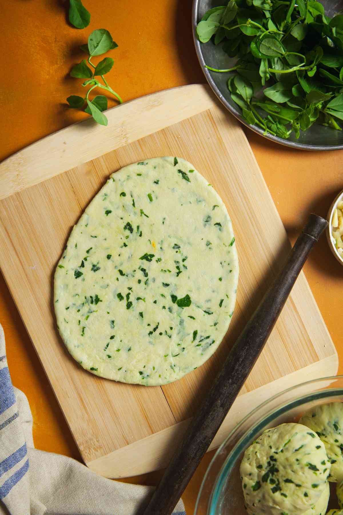 No yeast naan rolled on a floured surface.