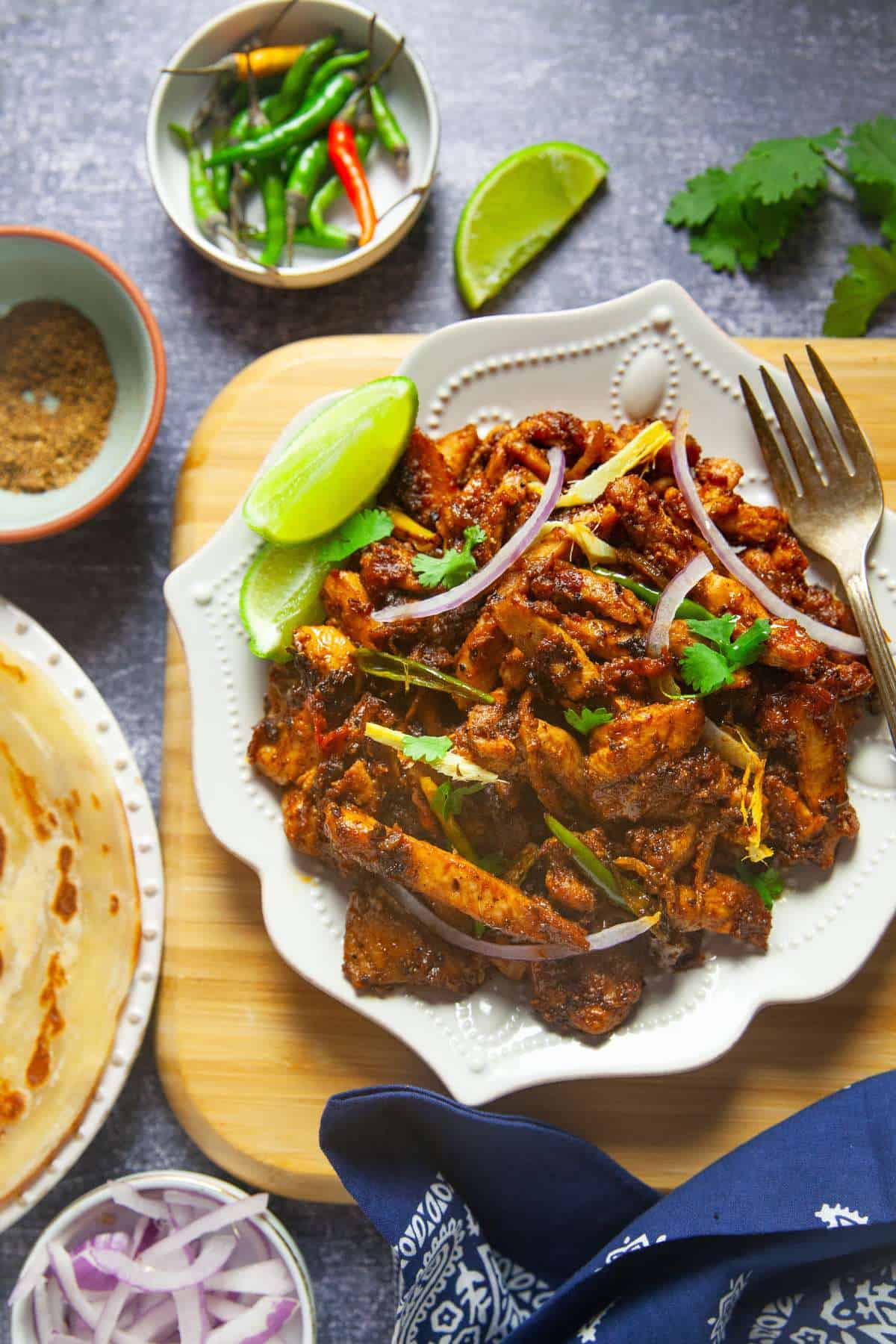 Tawa Chicken with paratha (flatbread), green chillies and onion.