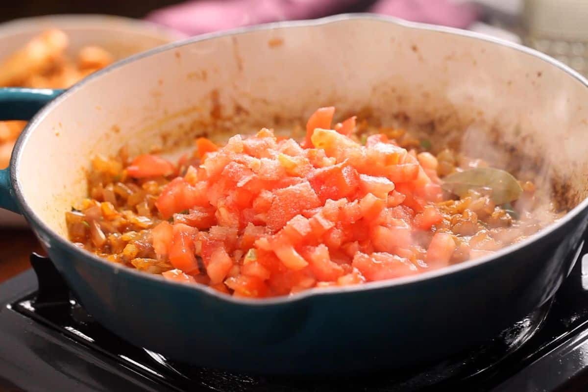 Tomatoes and salt are added to the tawa.