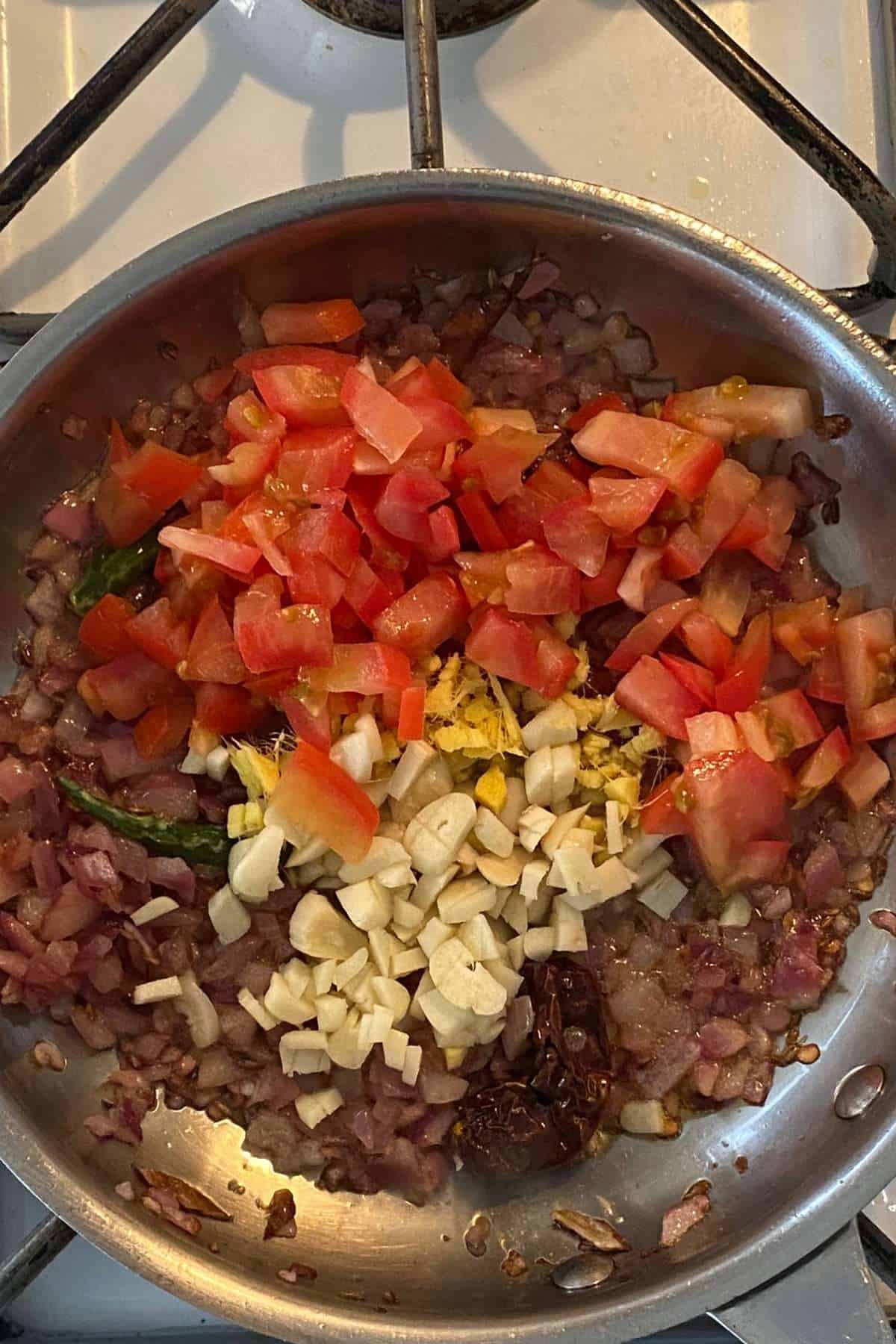 Add tomatoes, ginger garlic.