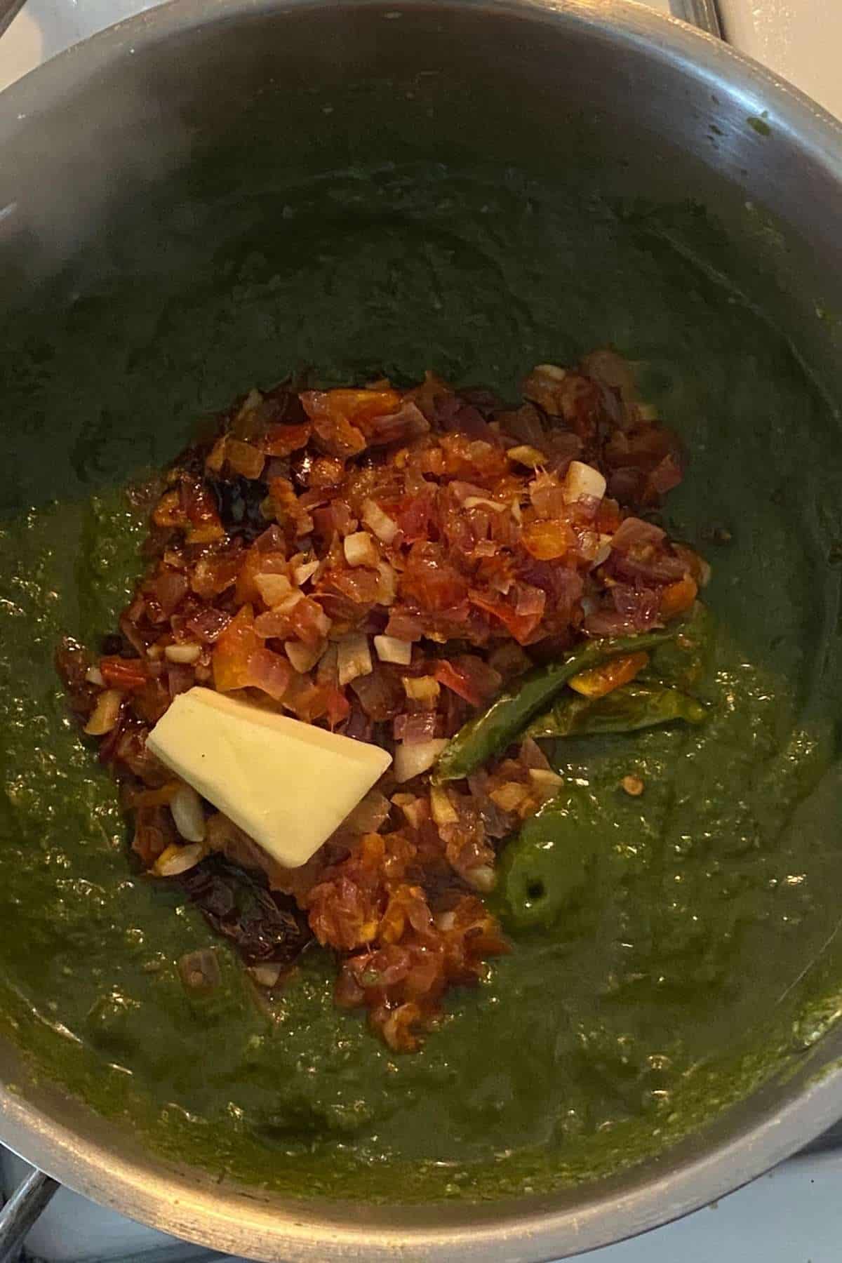 Add the tempering and butter to the saag and mix well.