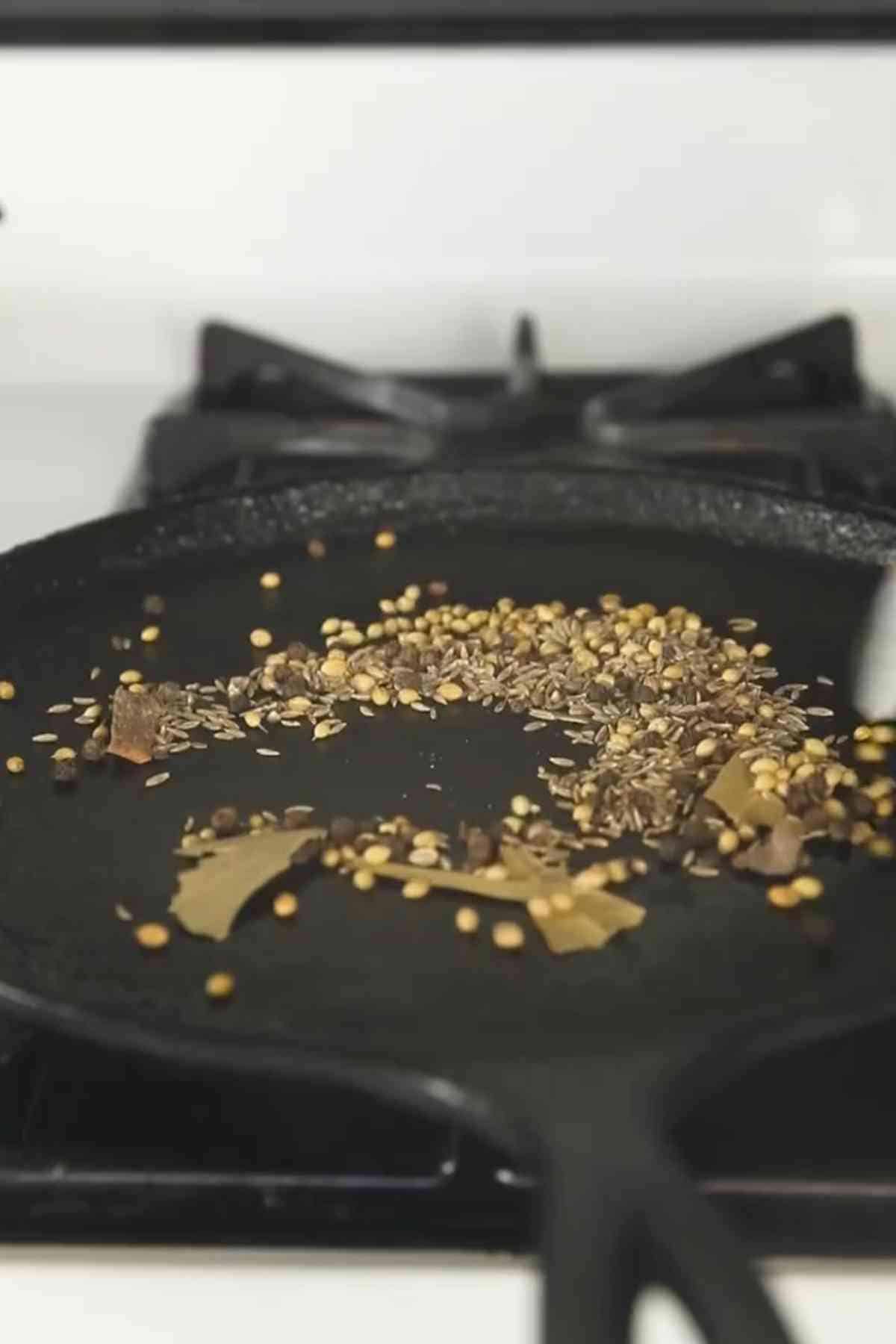 Dry roasting spices on a cast iron tawa.
