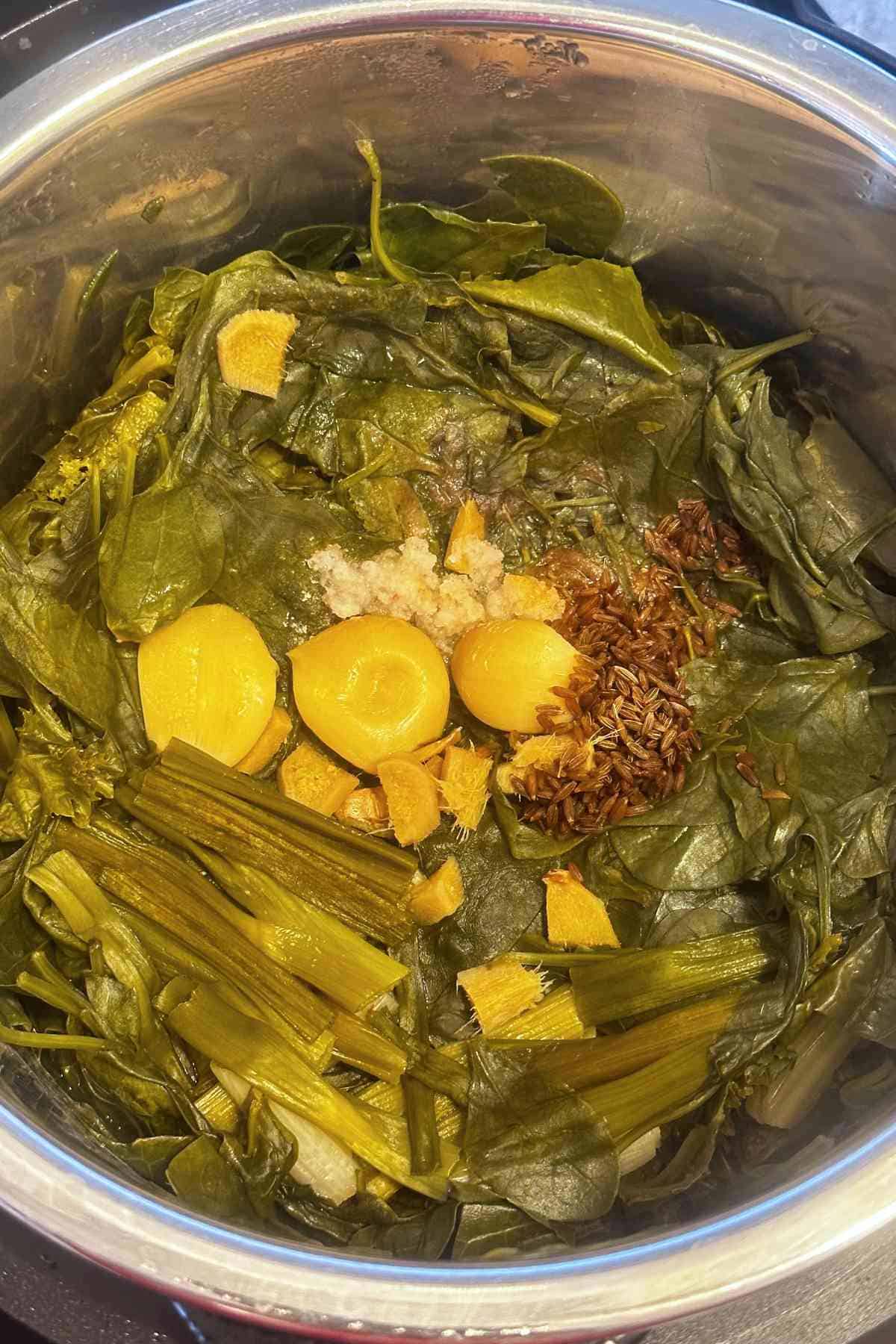 Mustrad greens and spices after pressure cooking in instant pot.