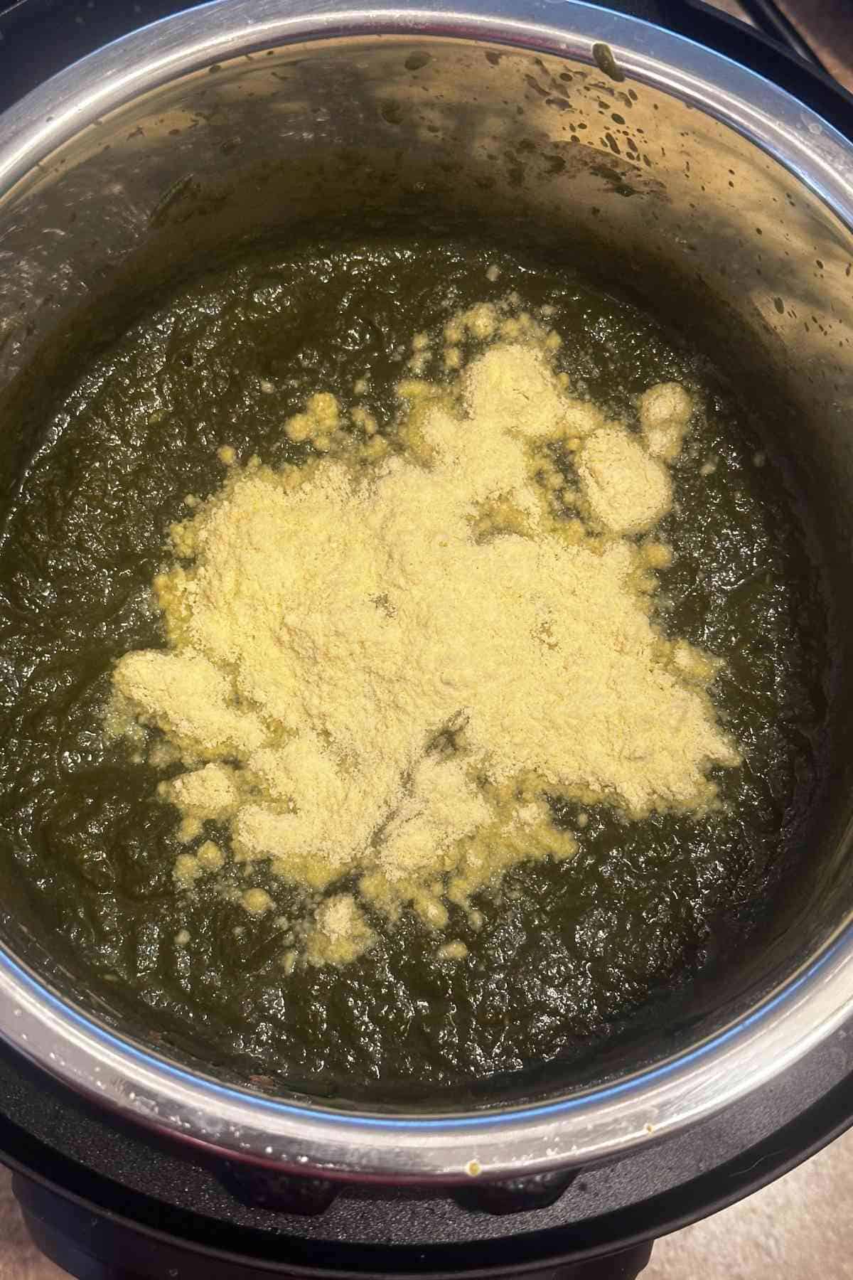 Makki atta or maize flour sprinkled on top of blended sarson saag.