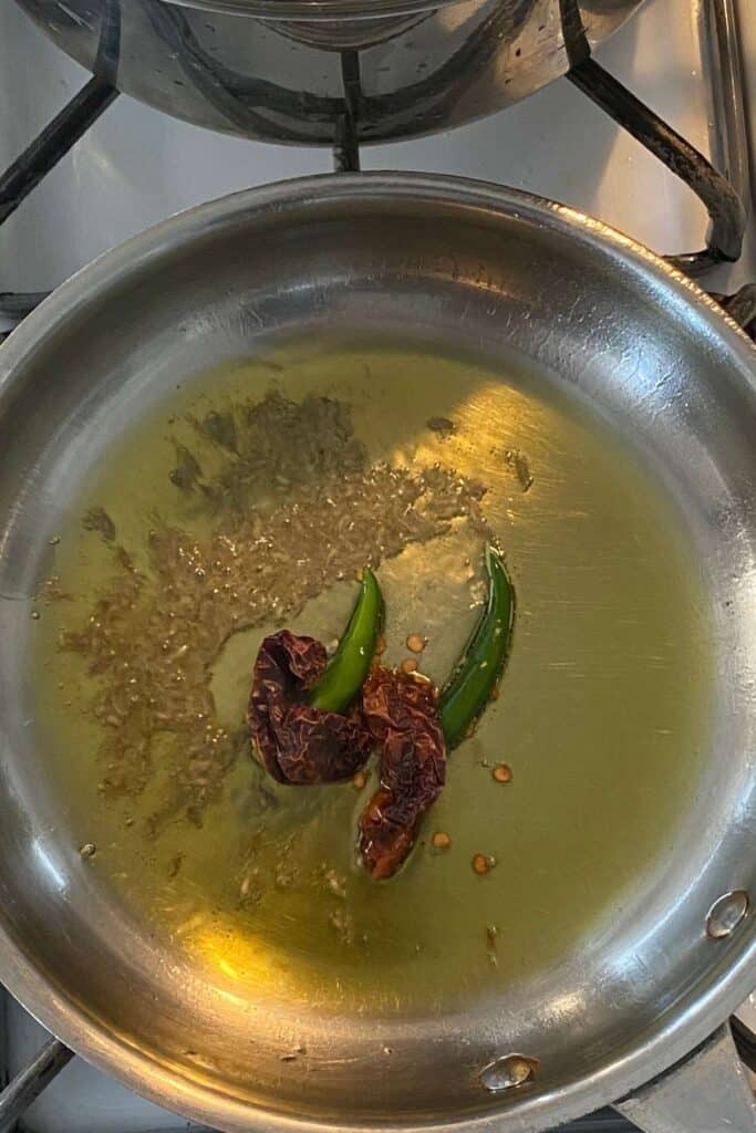 Temper mustard oil with spices and chillies.