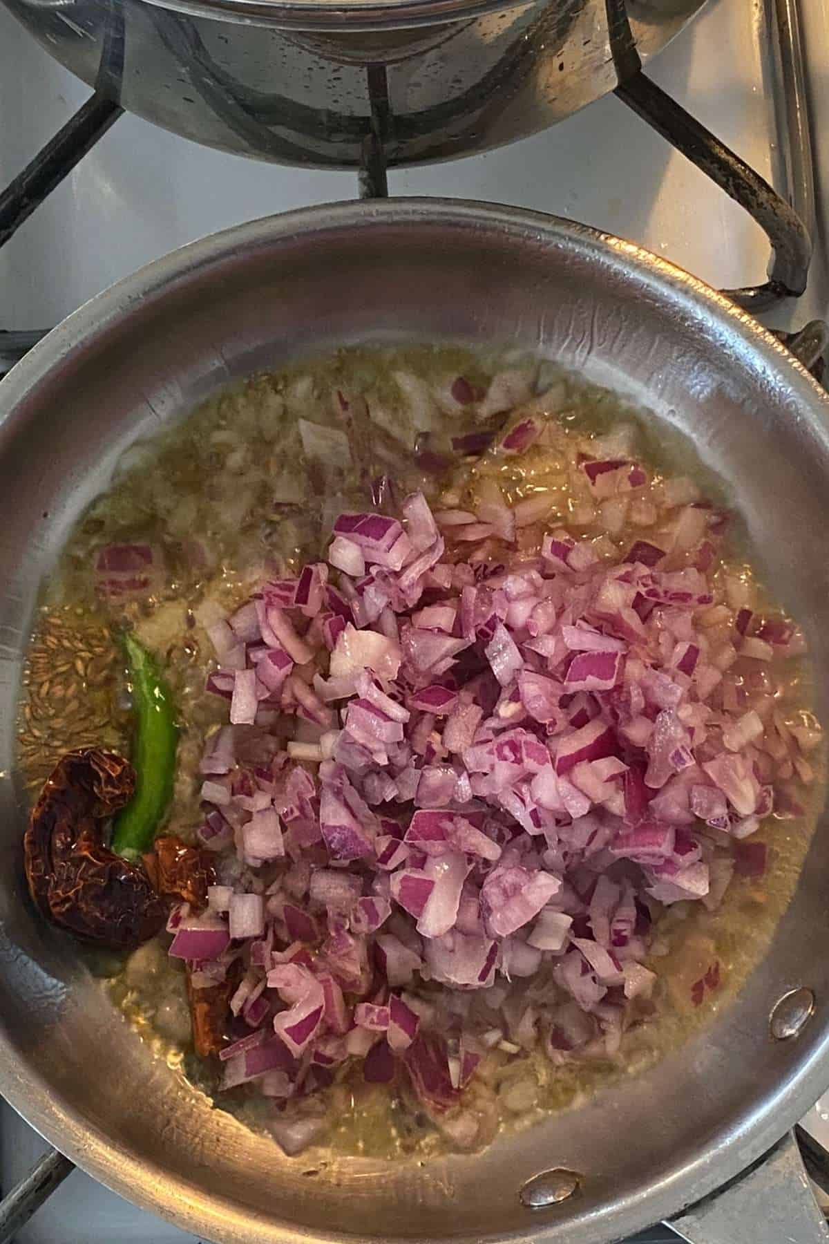 Add chopped onions to hot oil.