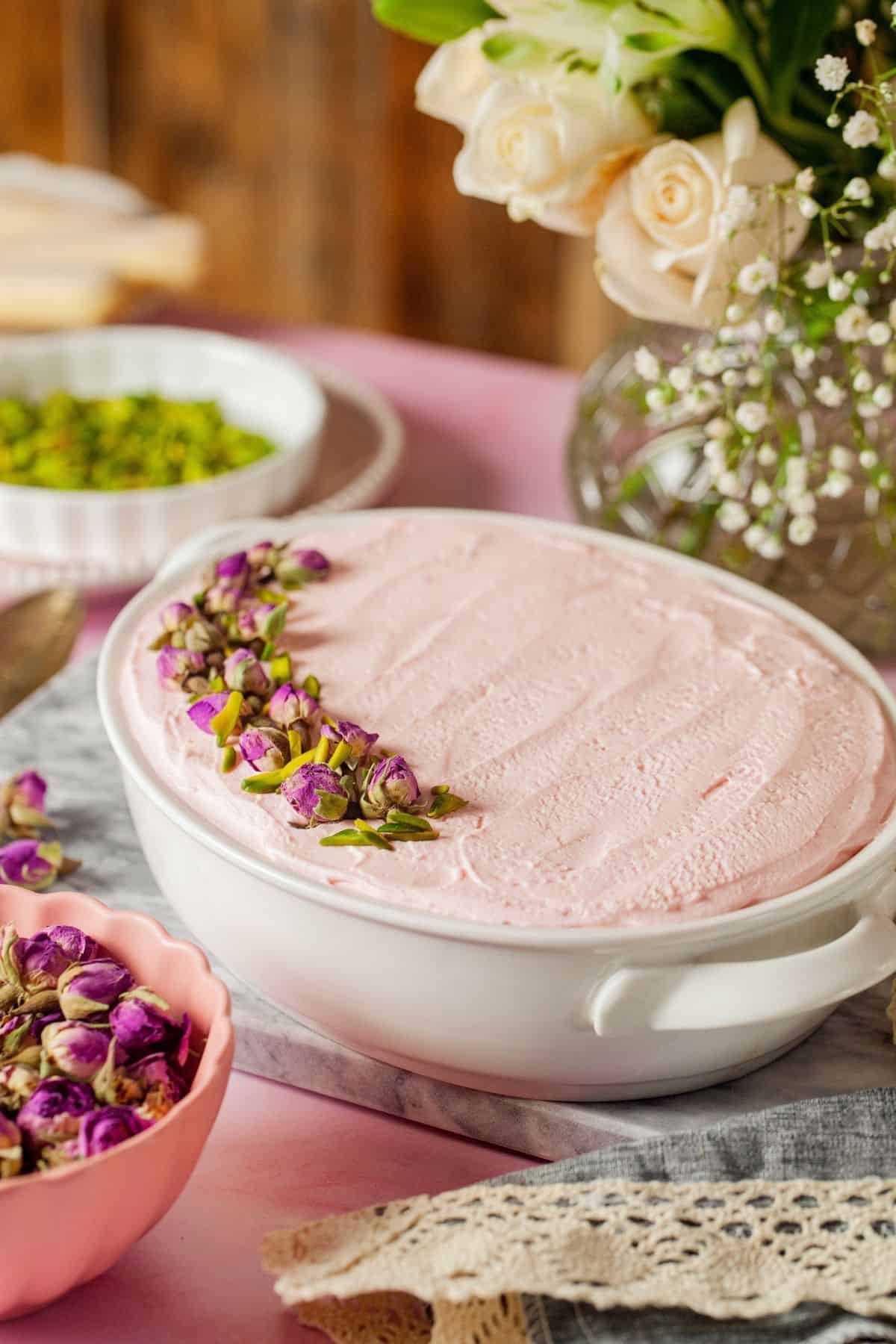 A dish containing layered Egg free Rose Tiramisu on a table 