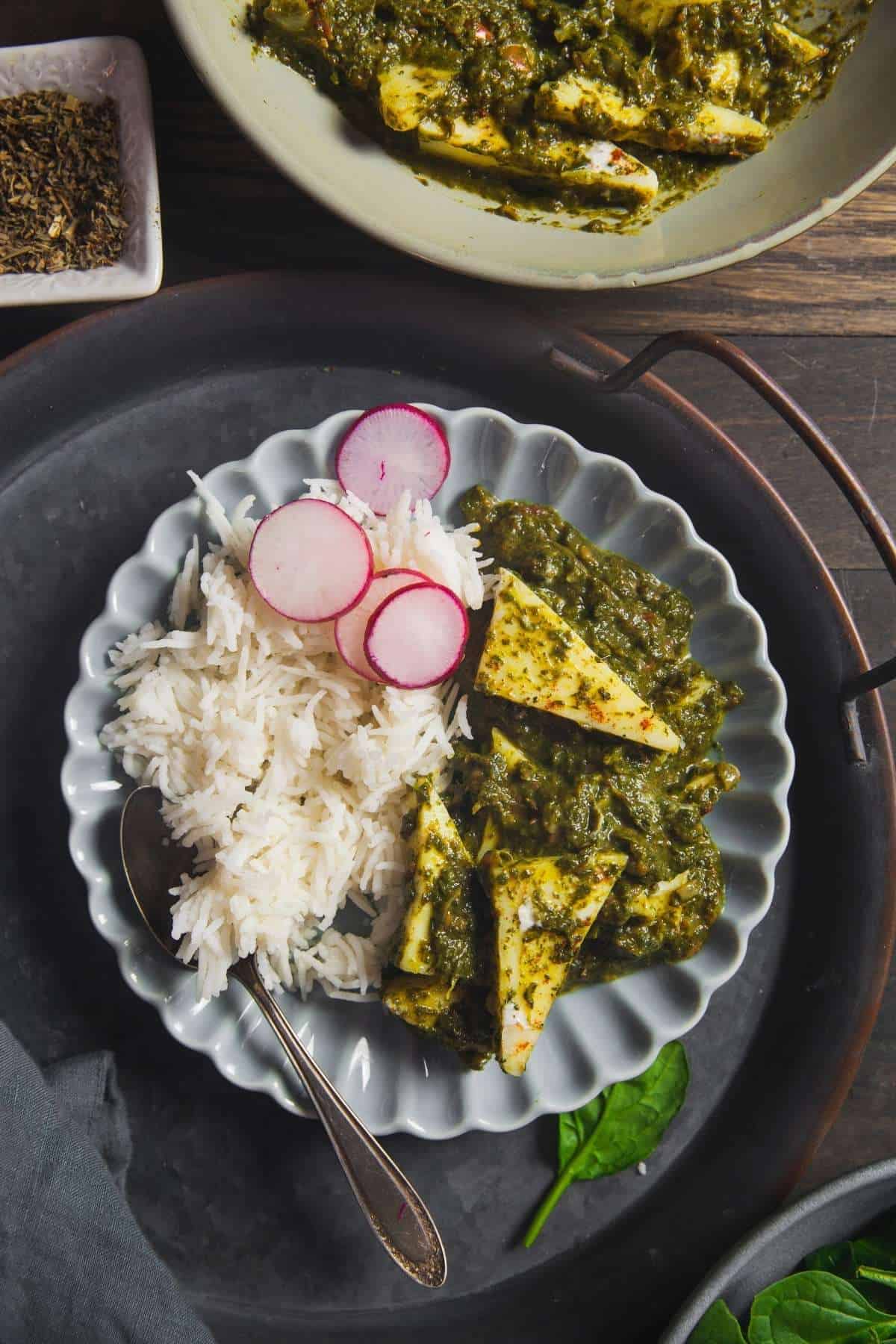 Sinfully Spicy - Palak Paneer With Rice in a scalloped plate