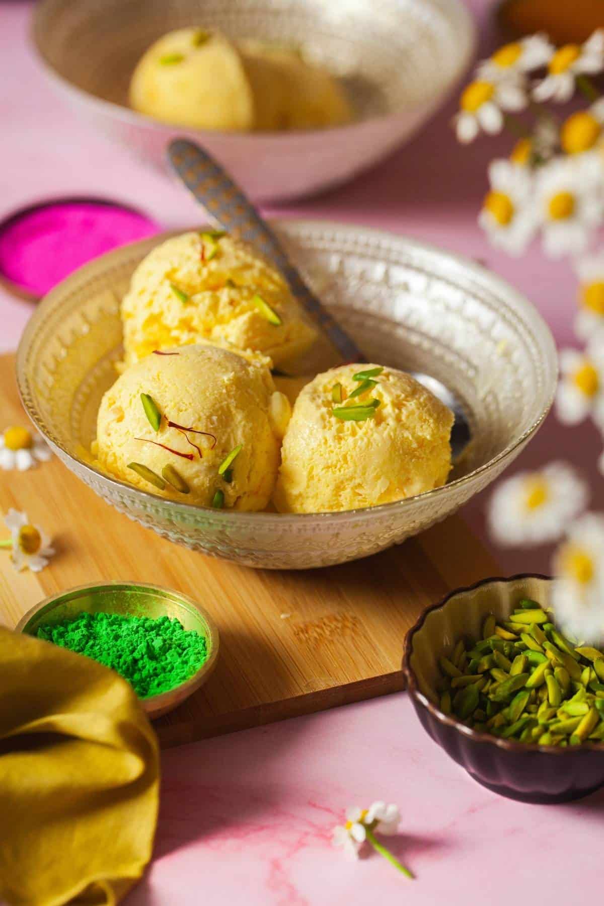 Three Scoops of Saffron Mango Frozen Yogurt in a pretty bowl